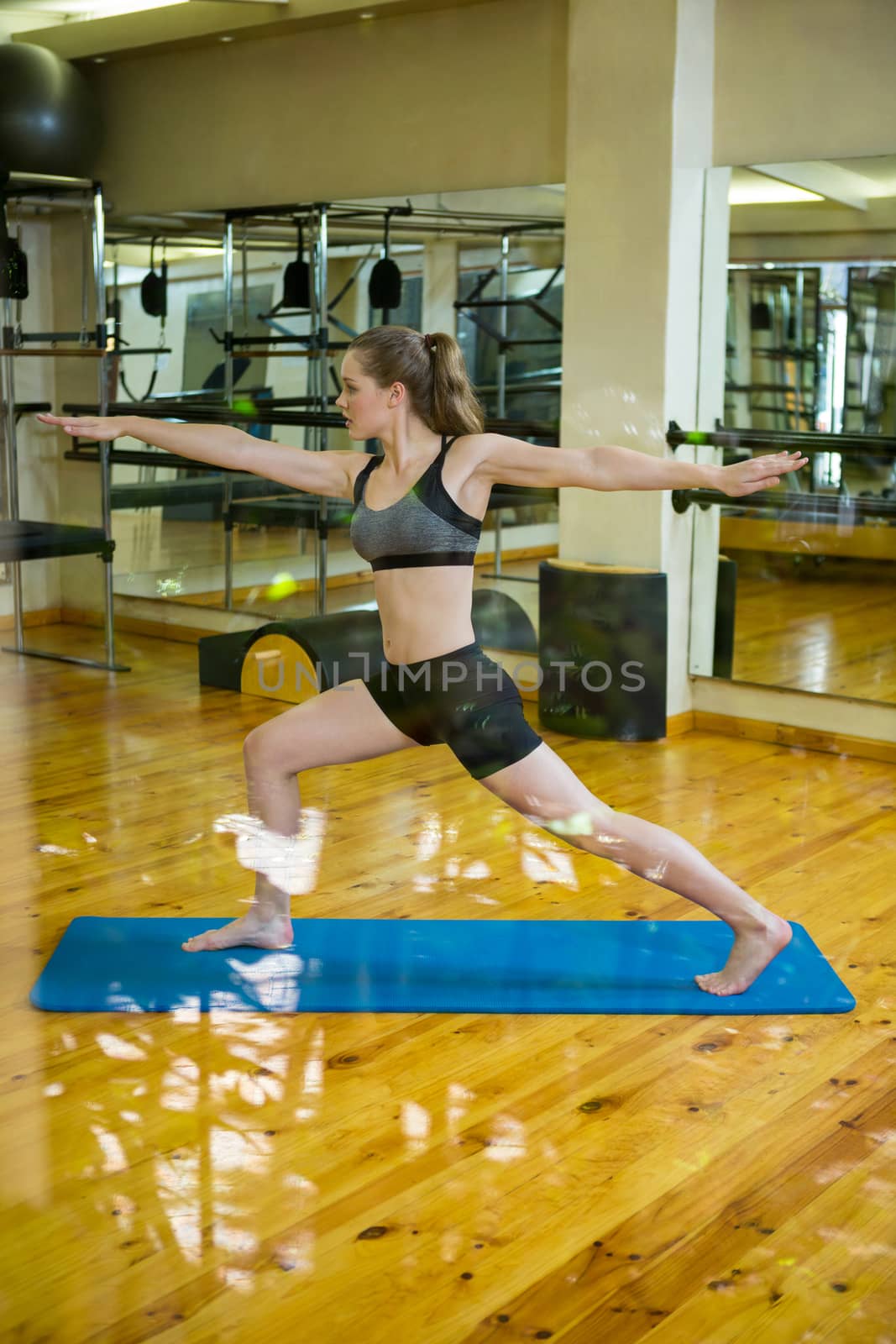 Beautiful woman practicing yoga in gym