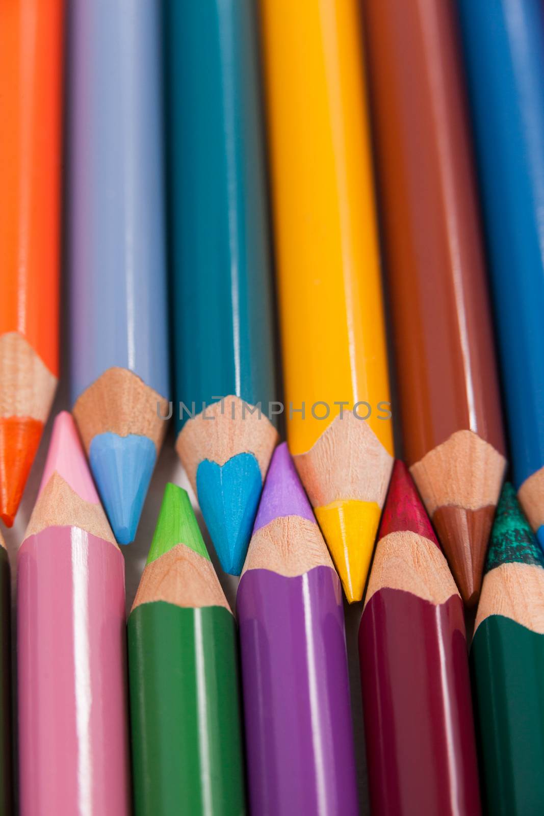 Close-up of colored pencils arranged in interlock pattern