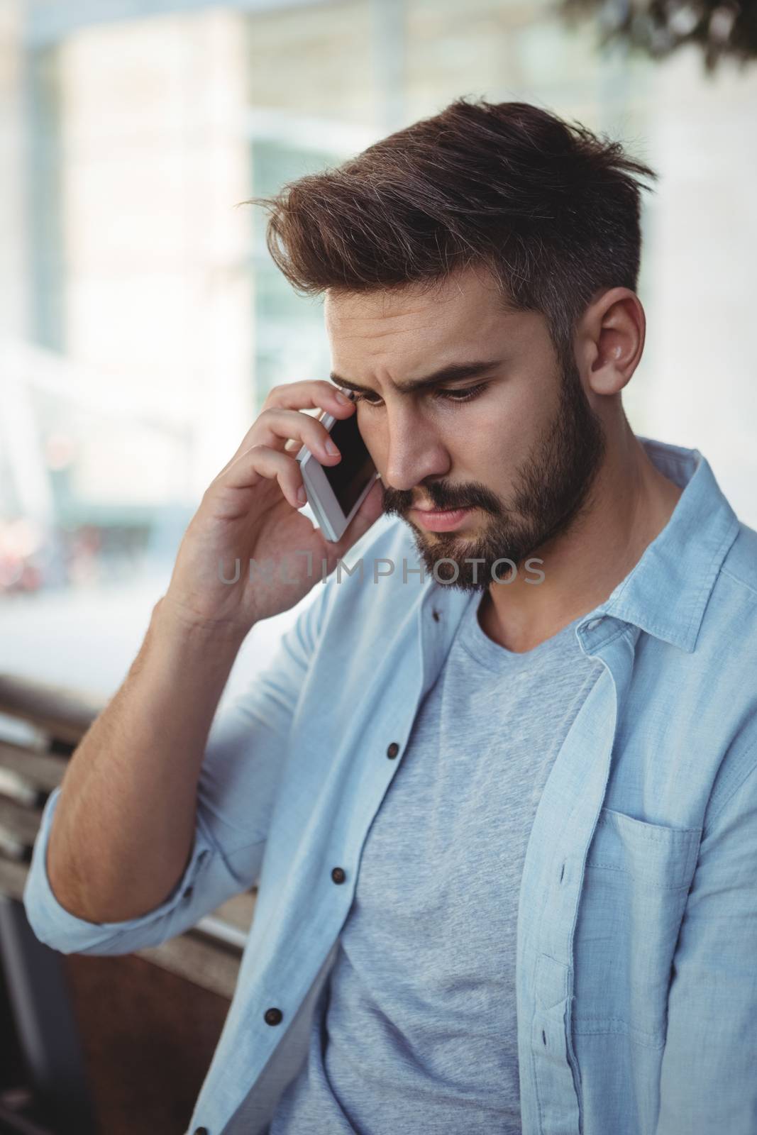 Executive talking on mobile phone in park