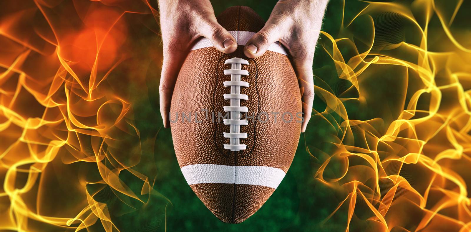 American football player holding up football against abstract orange glowing black background
