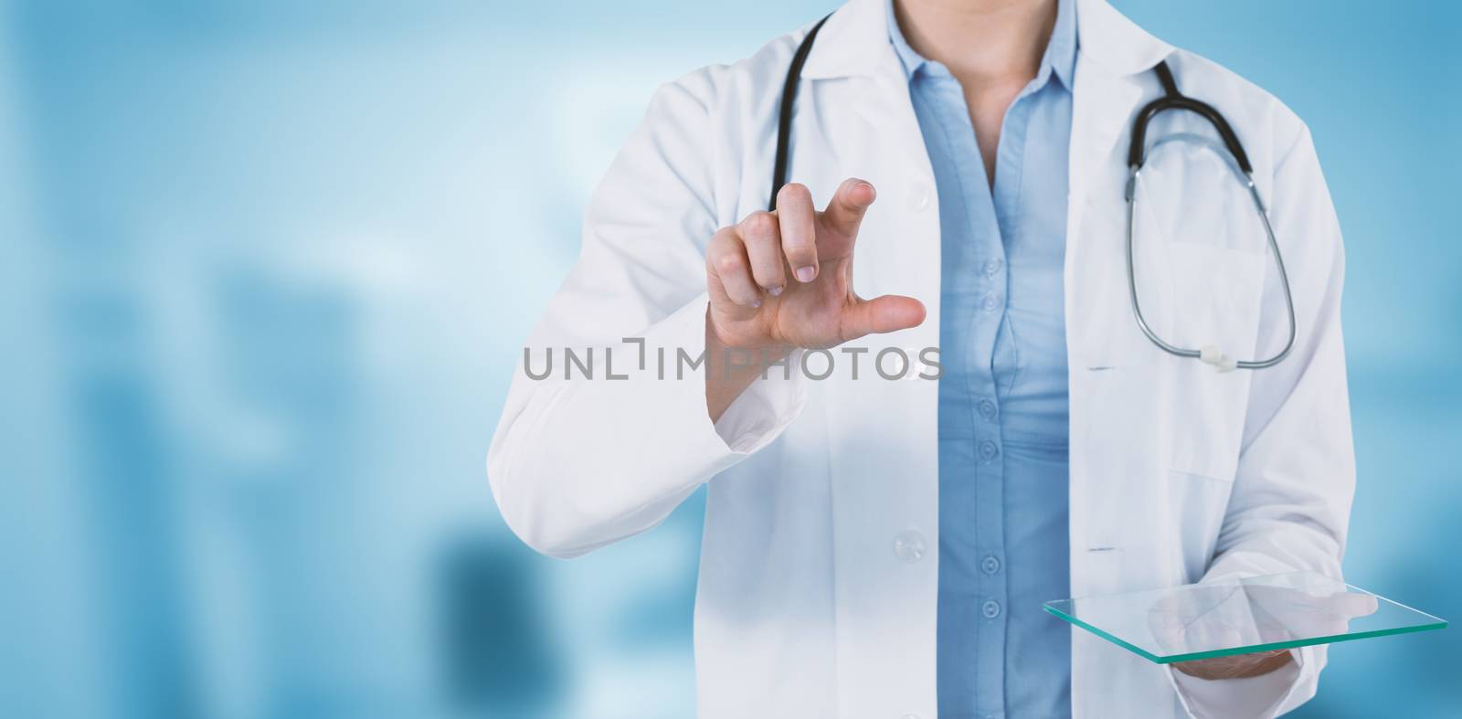 Composite image of cropped image of female doctor holding digital tablet while using invisible scree by Wavebreakmedia