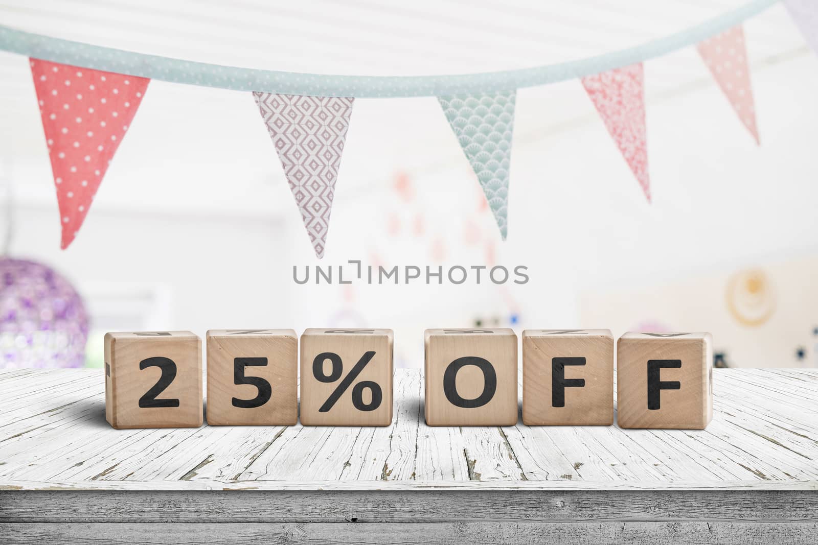 Special price 25 percent off promotion sign on a desk with colorful flags above