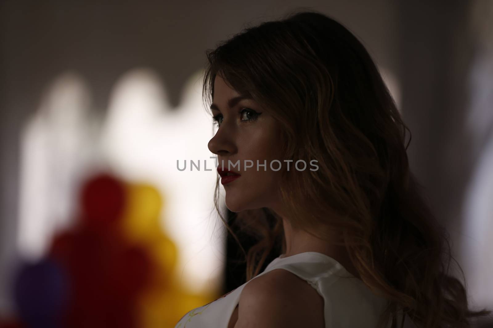 Portrait of a model in dark light at a fashion show.Luxurious young girl in the evening with a mysterious look