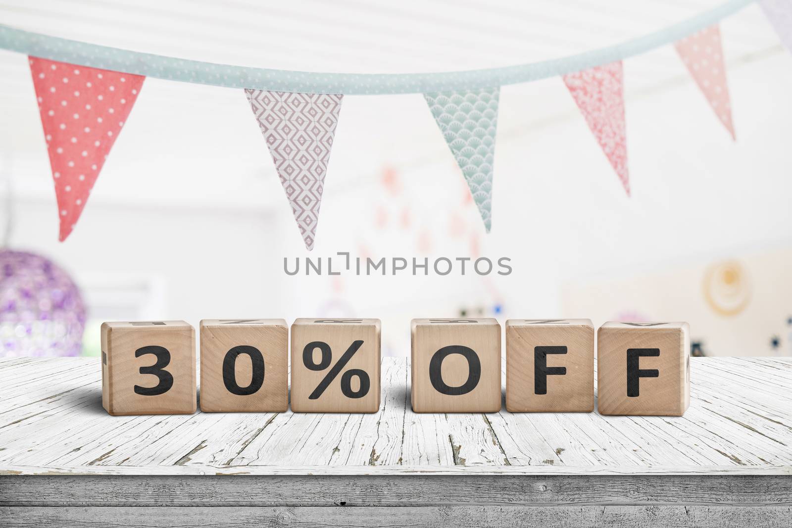 Special price 30 percent off promotion sign on a desk with colorful flags above