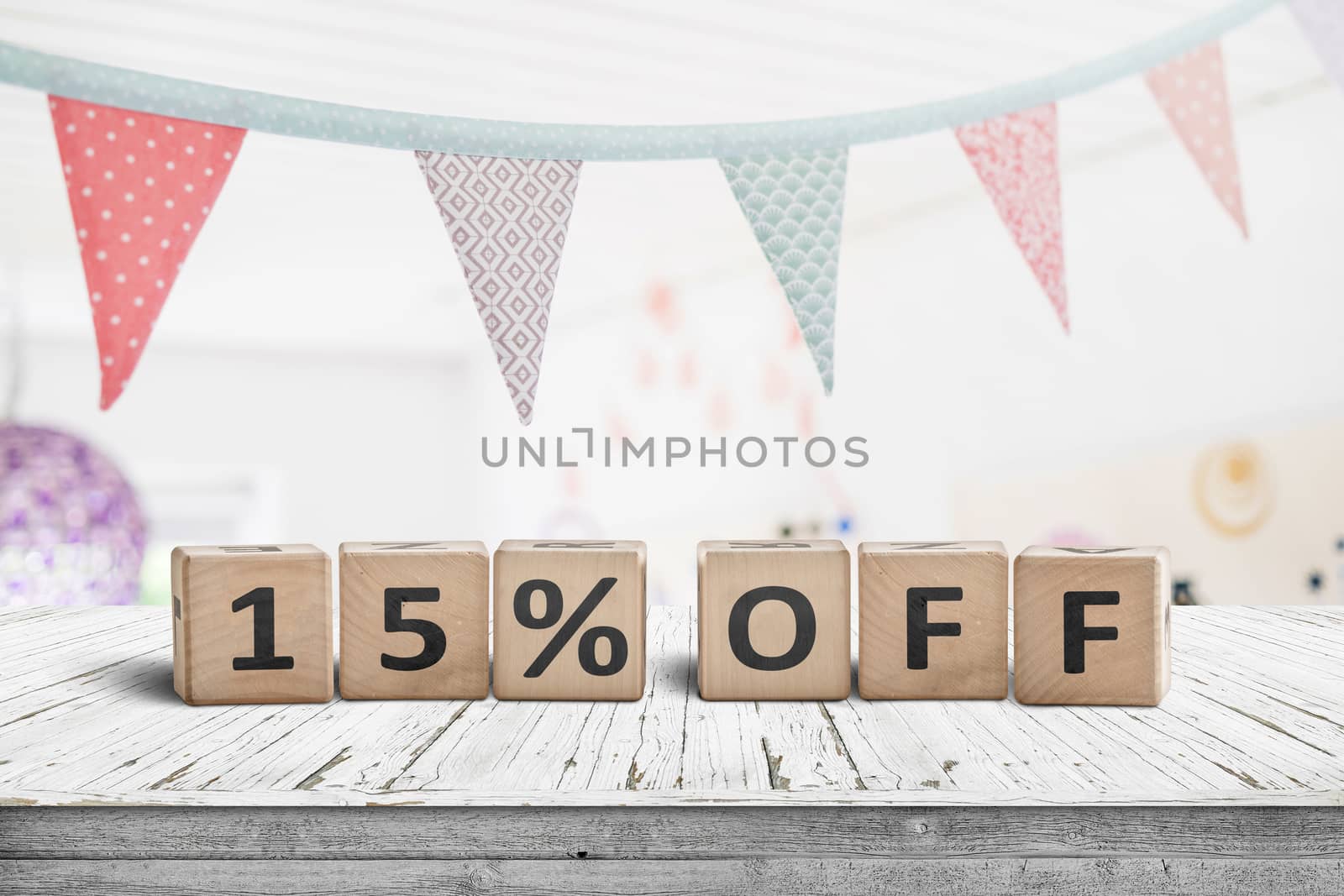 Special price 15 percent off promotion sign on a desk with colorful flags above