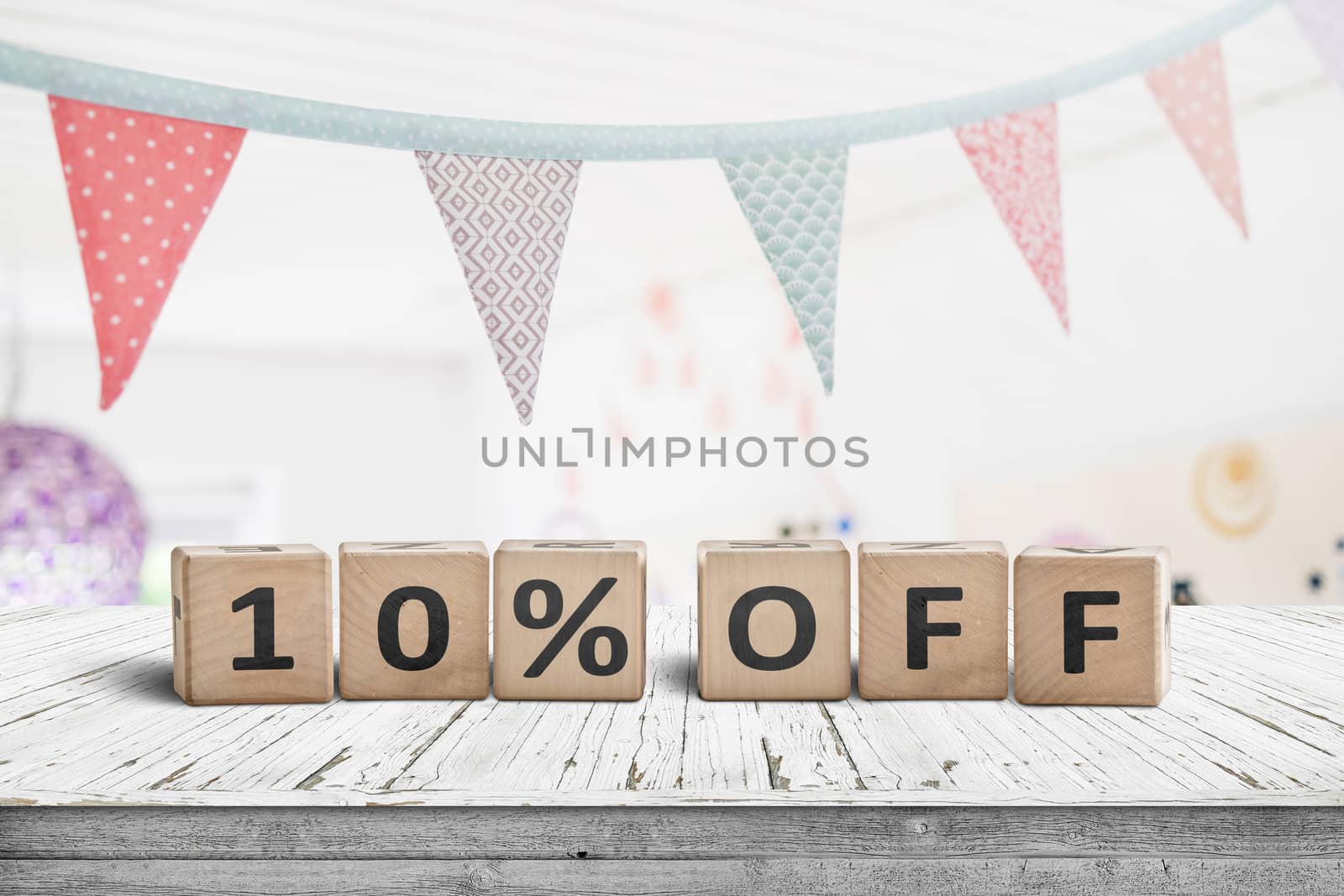 Special price 10 percent off promotion sign on a desk with colorful flags above
