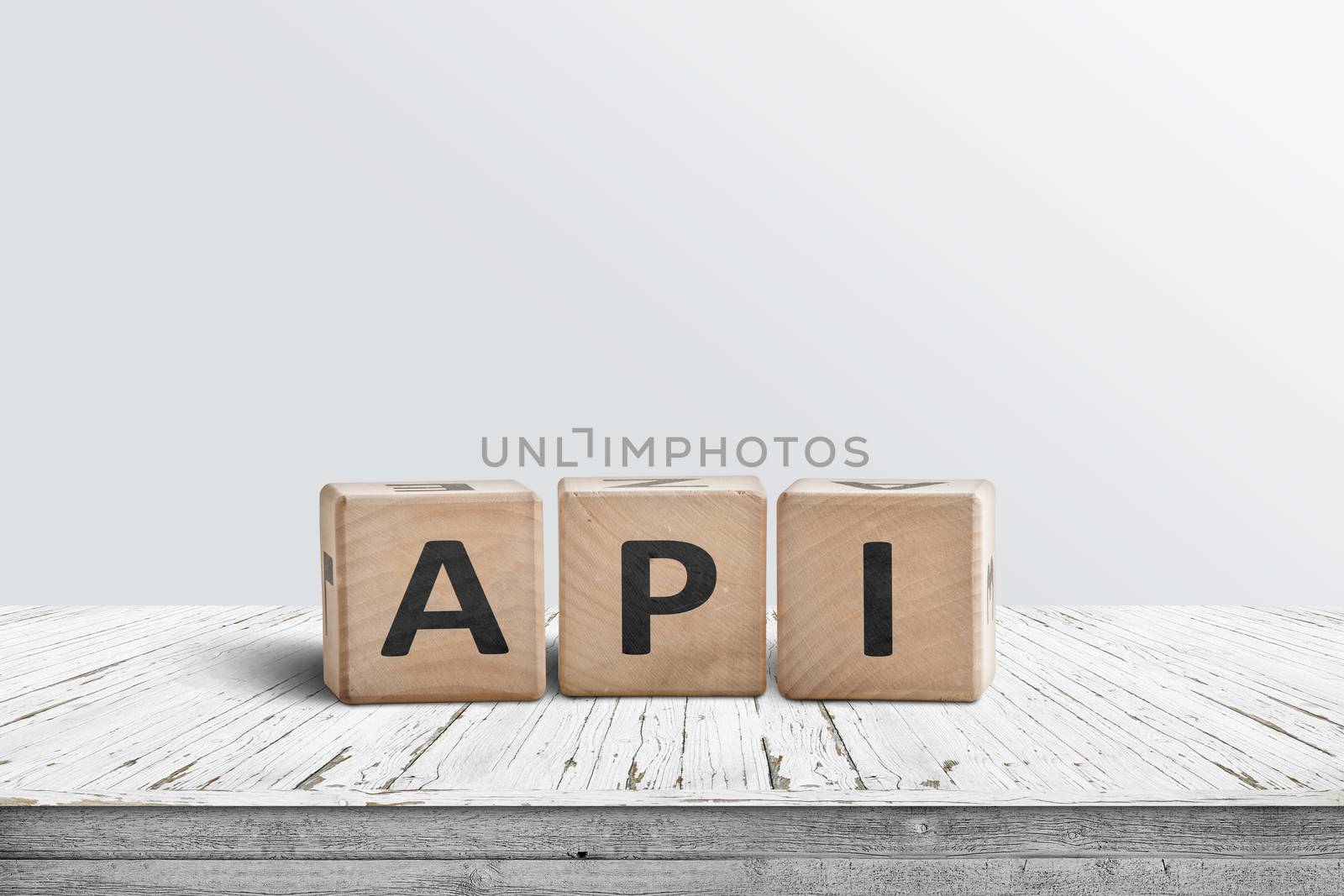 API app programming sign made of wooden blocks on a white desk