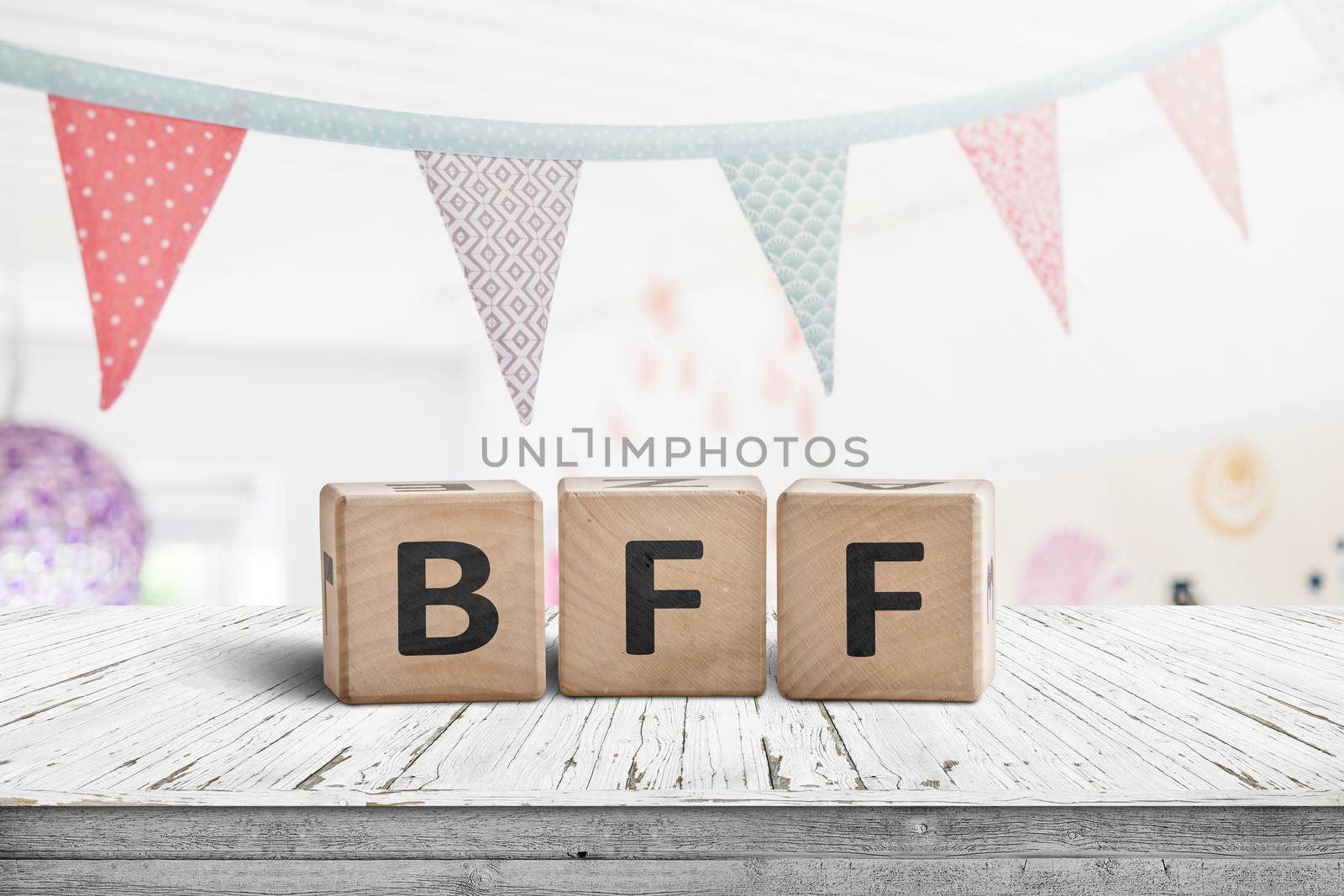 BFF greeting message made of wooden blocks with colorful flags hanging above