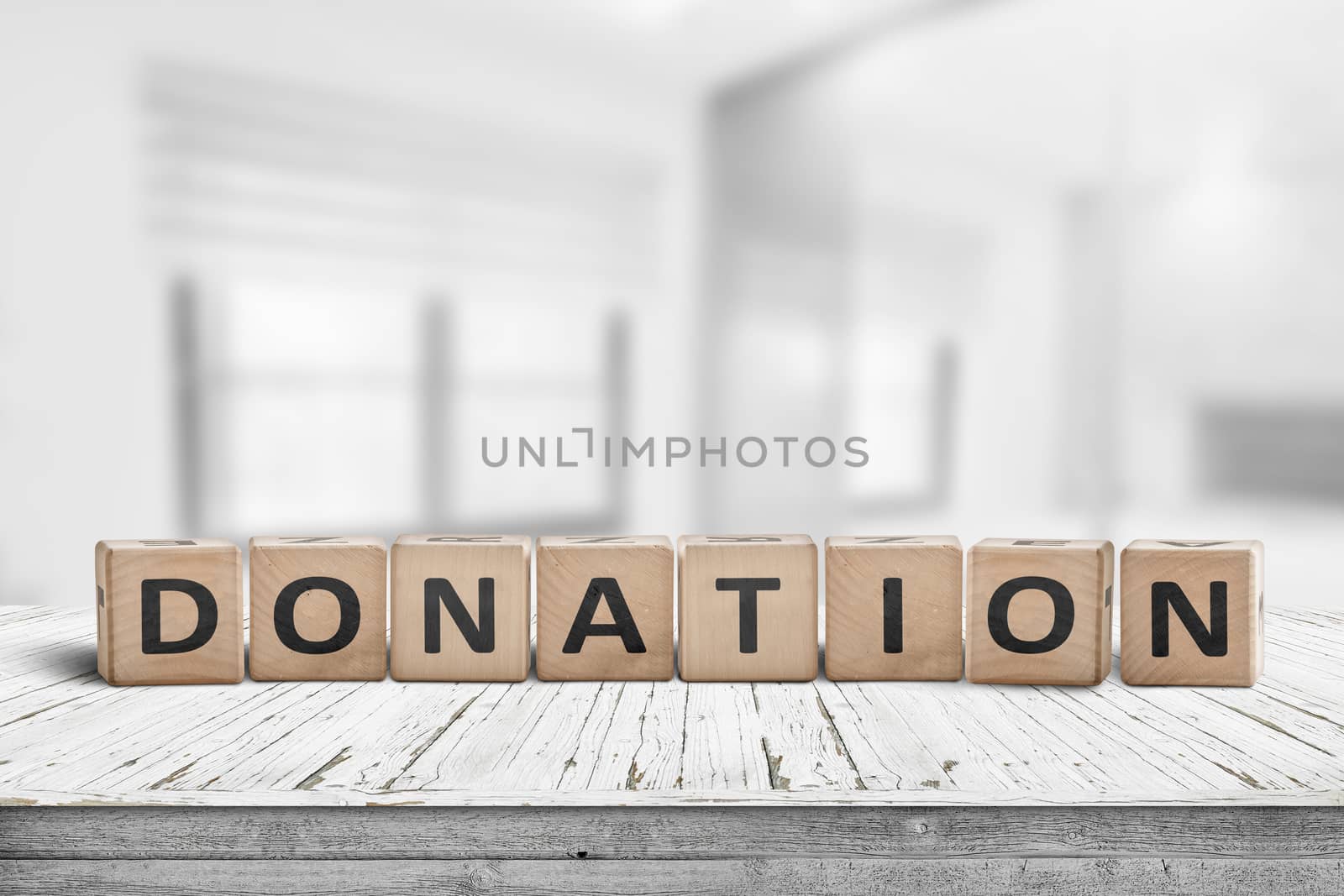 Wooden donation sign on a worn desk in a bright room with lights