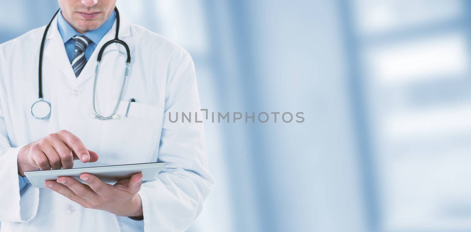 Composite image of young doctor using digital tablet by Wavebreakmedia