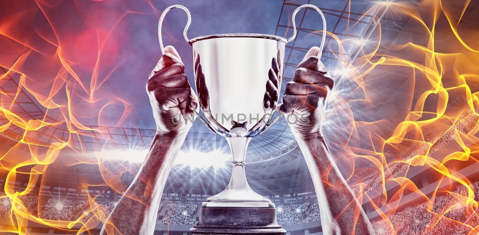 Composite image of hand of athlete holding trophy by Wavebreakmedia