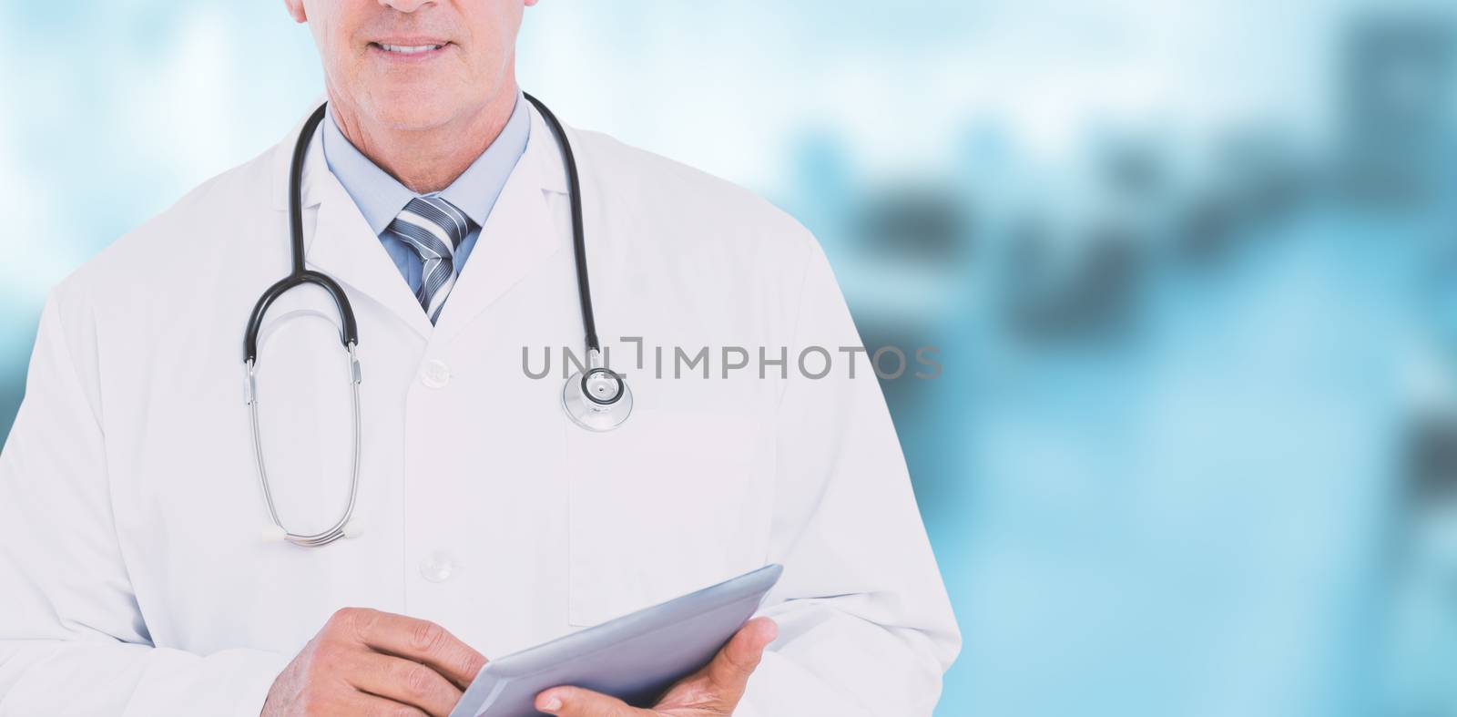 Composite image of smiling doctor looking at camera and holding tablet by Wavebreakmedia