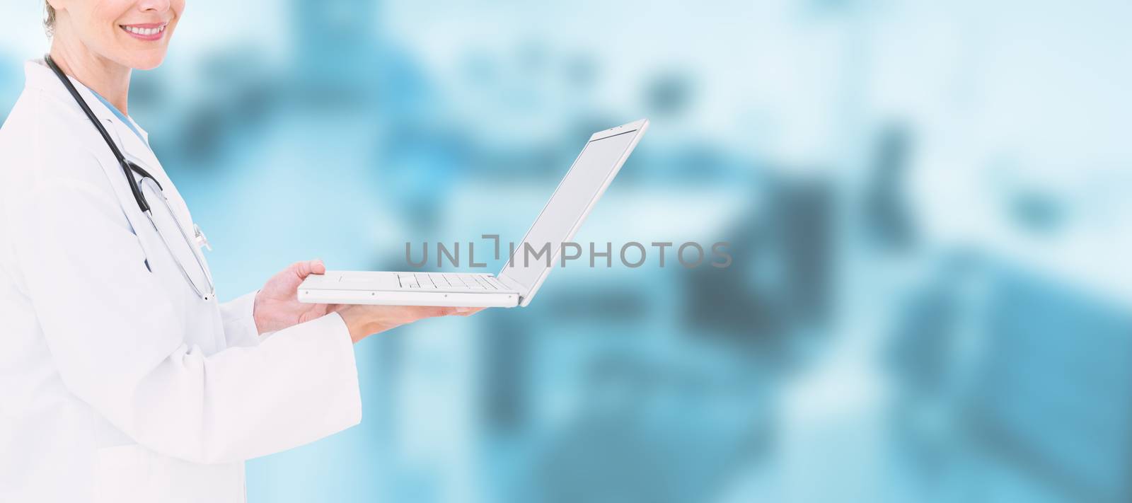Blonde doctor using laptop against dental equipment
