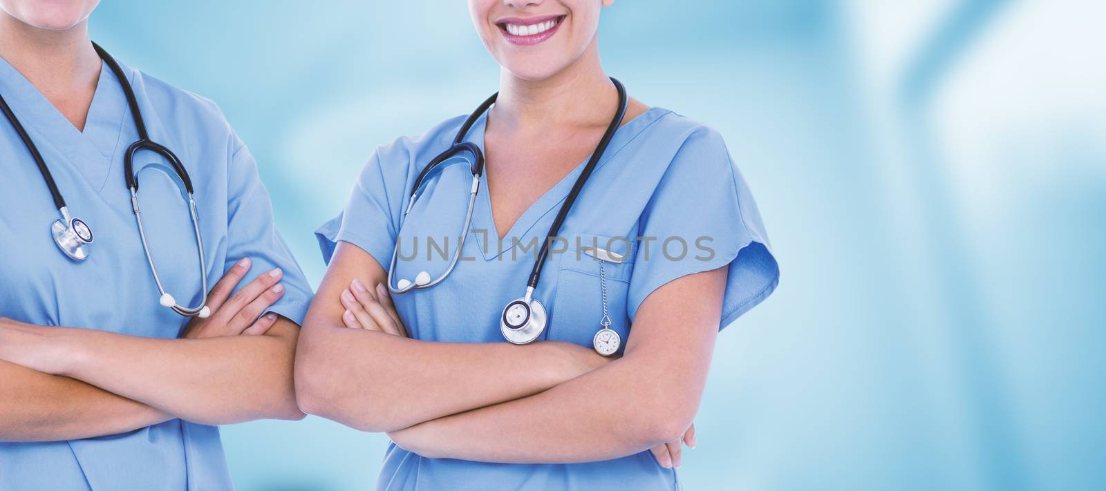 Portrait of beautiful female doctors against dental equipment