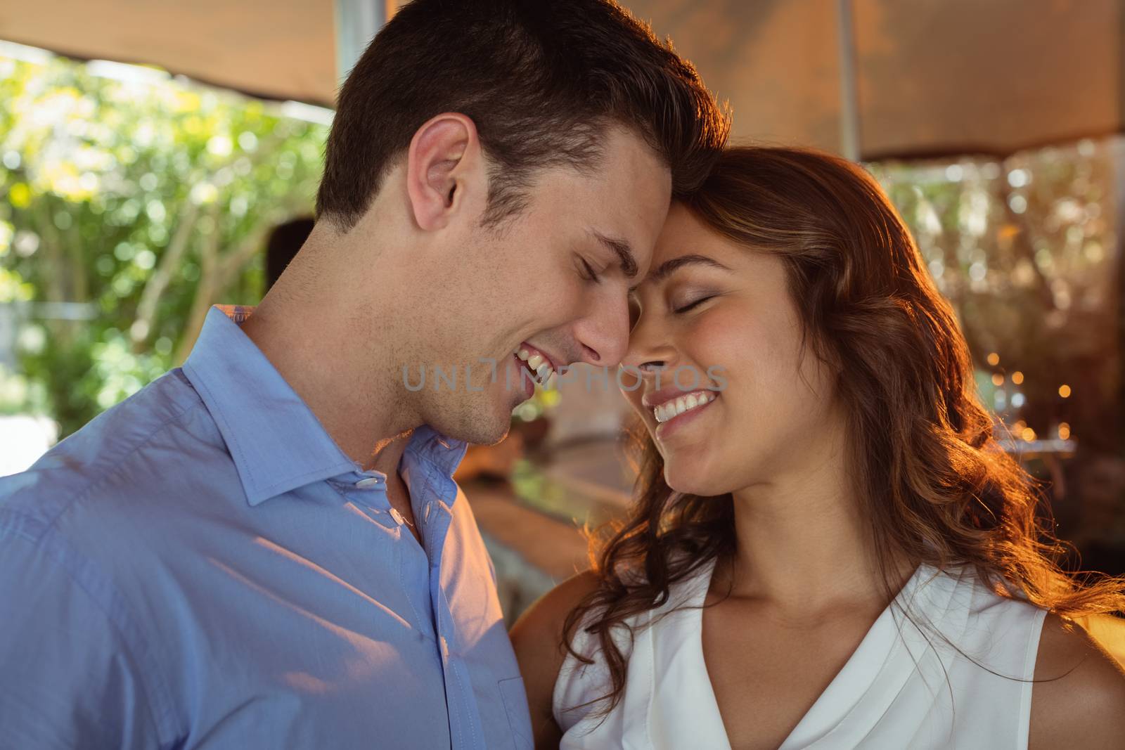 Romantic couple looking face to face in restaurant