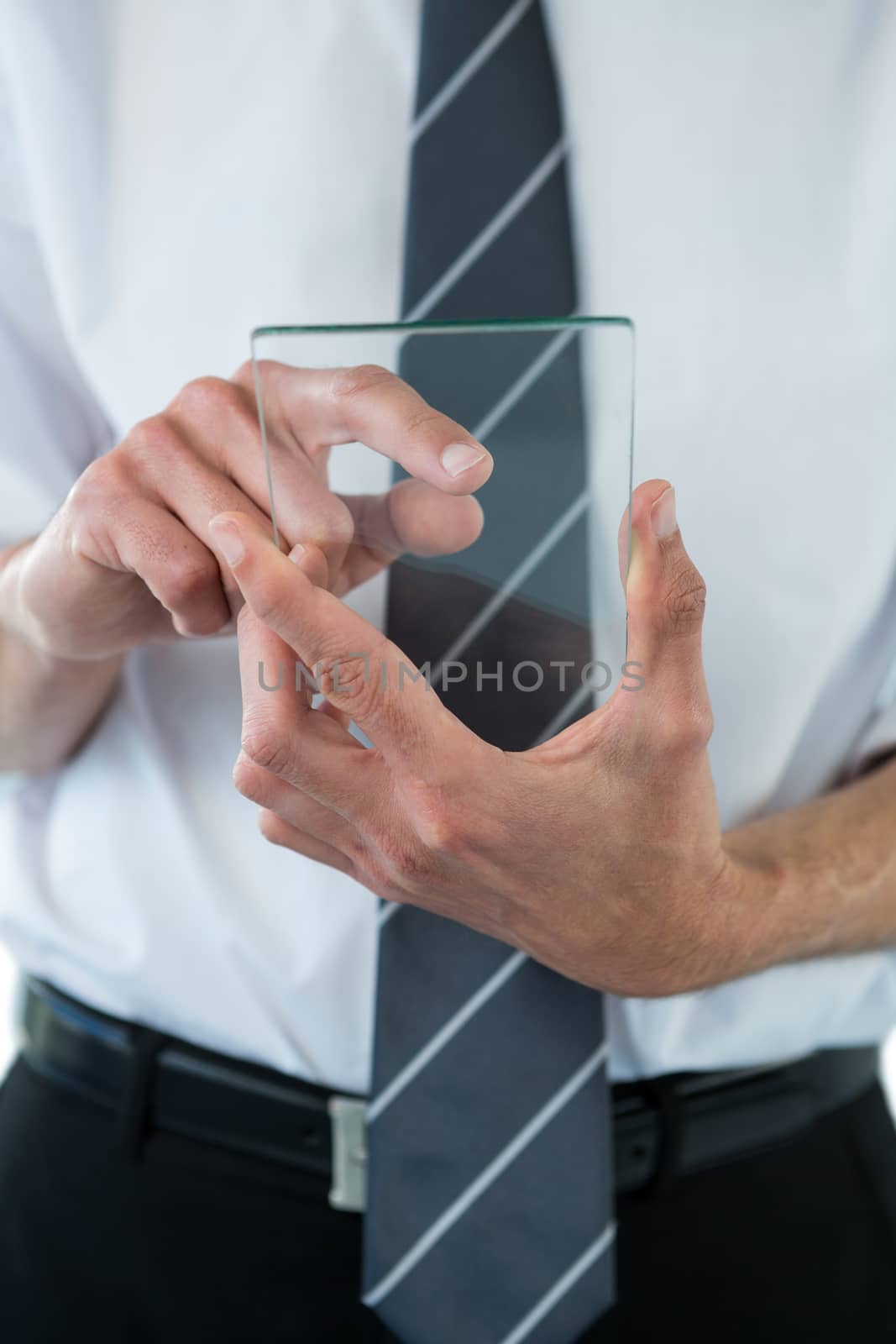 Mid section of businessman using futuristic mobile phone