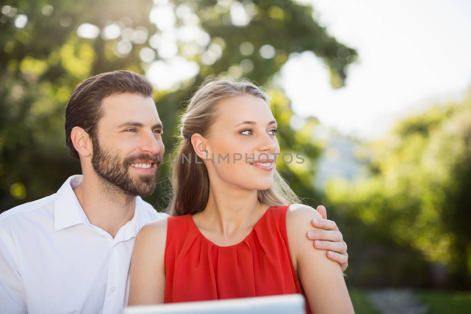 Couple together in park on a sunny day by Wavebreakmedia