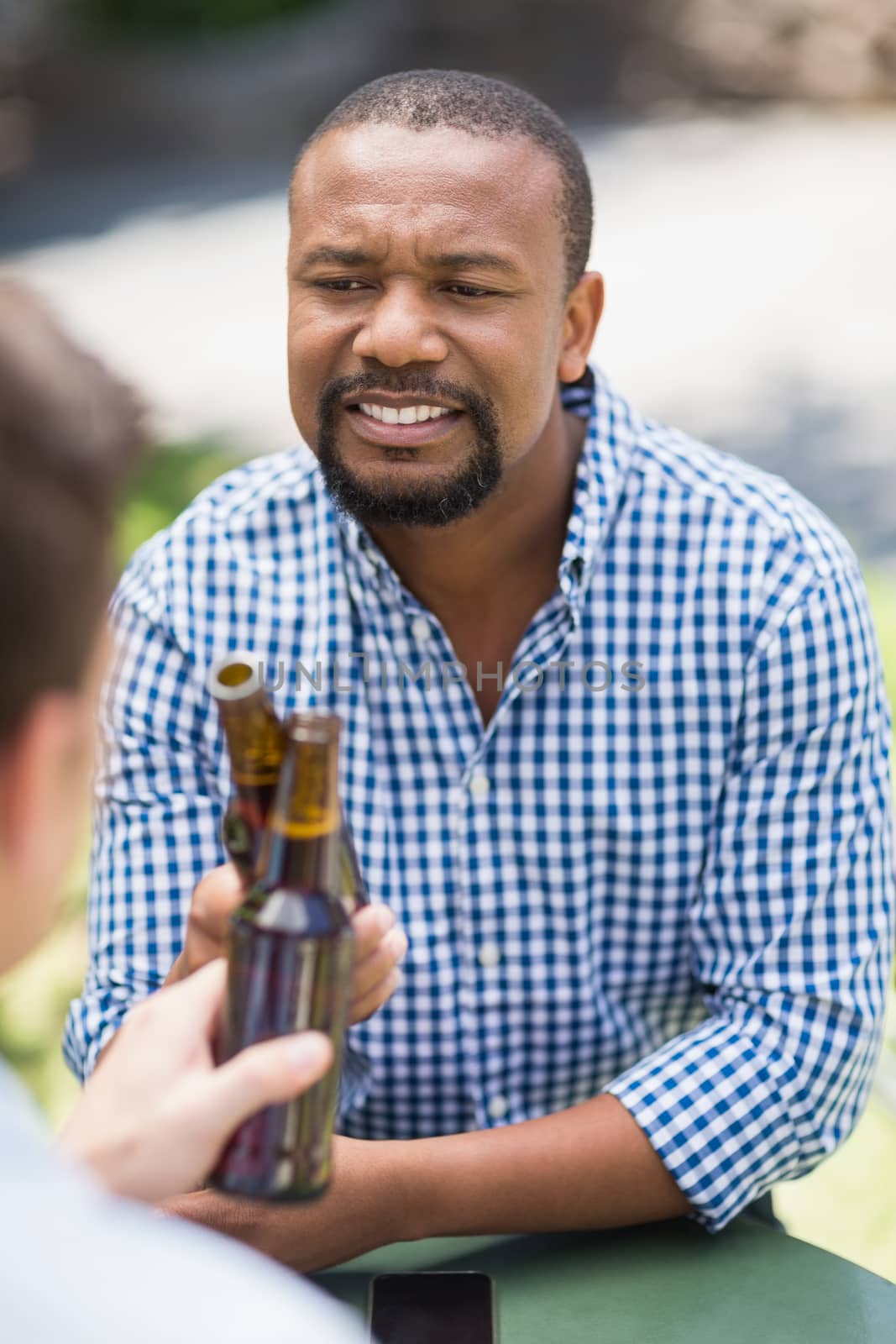 Friends toasting beer bottles in the restaurant