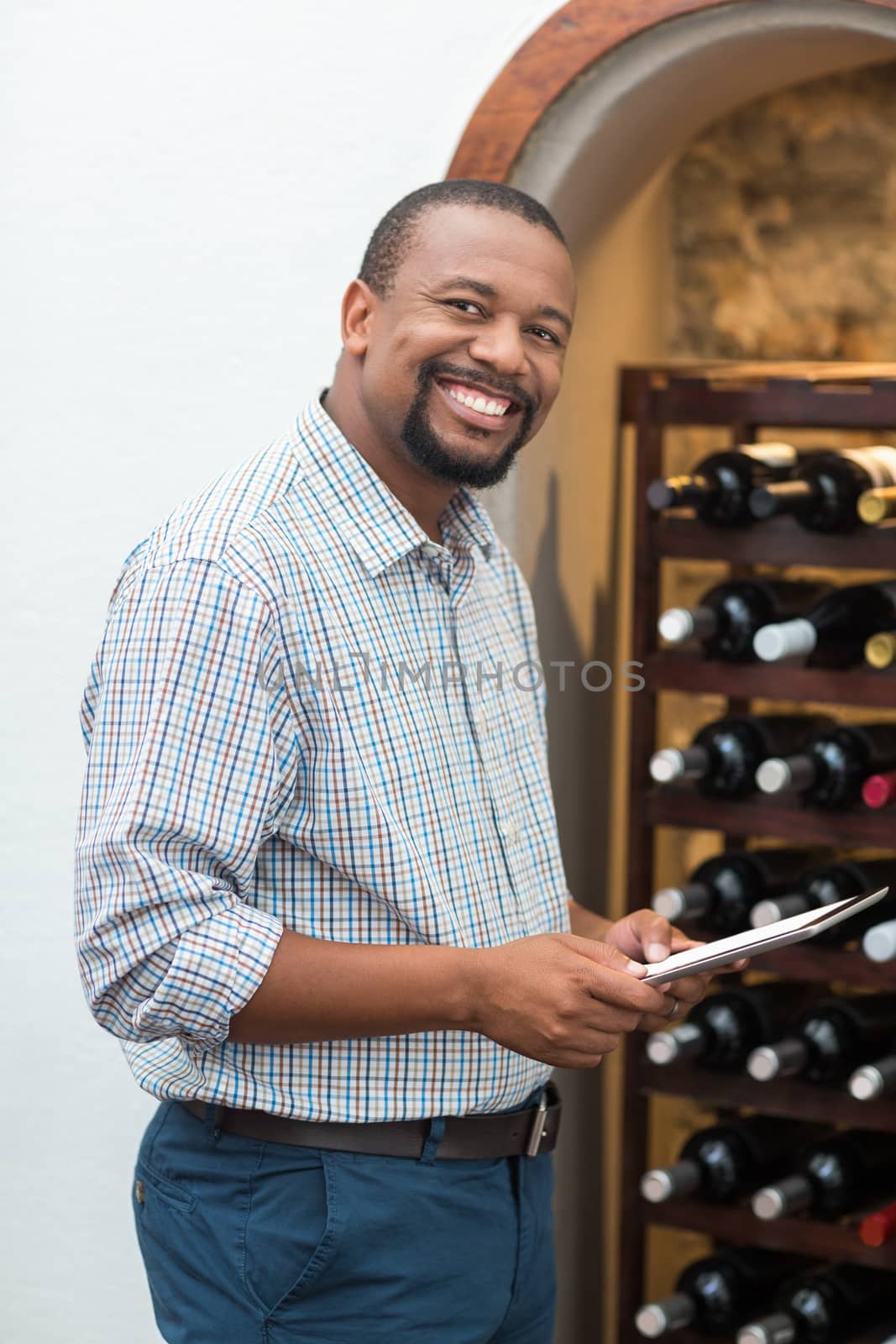 Happy man using digital tablet in the restaurant by Wavebreakmedia