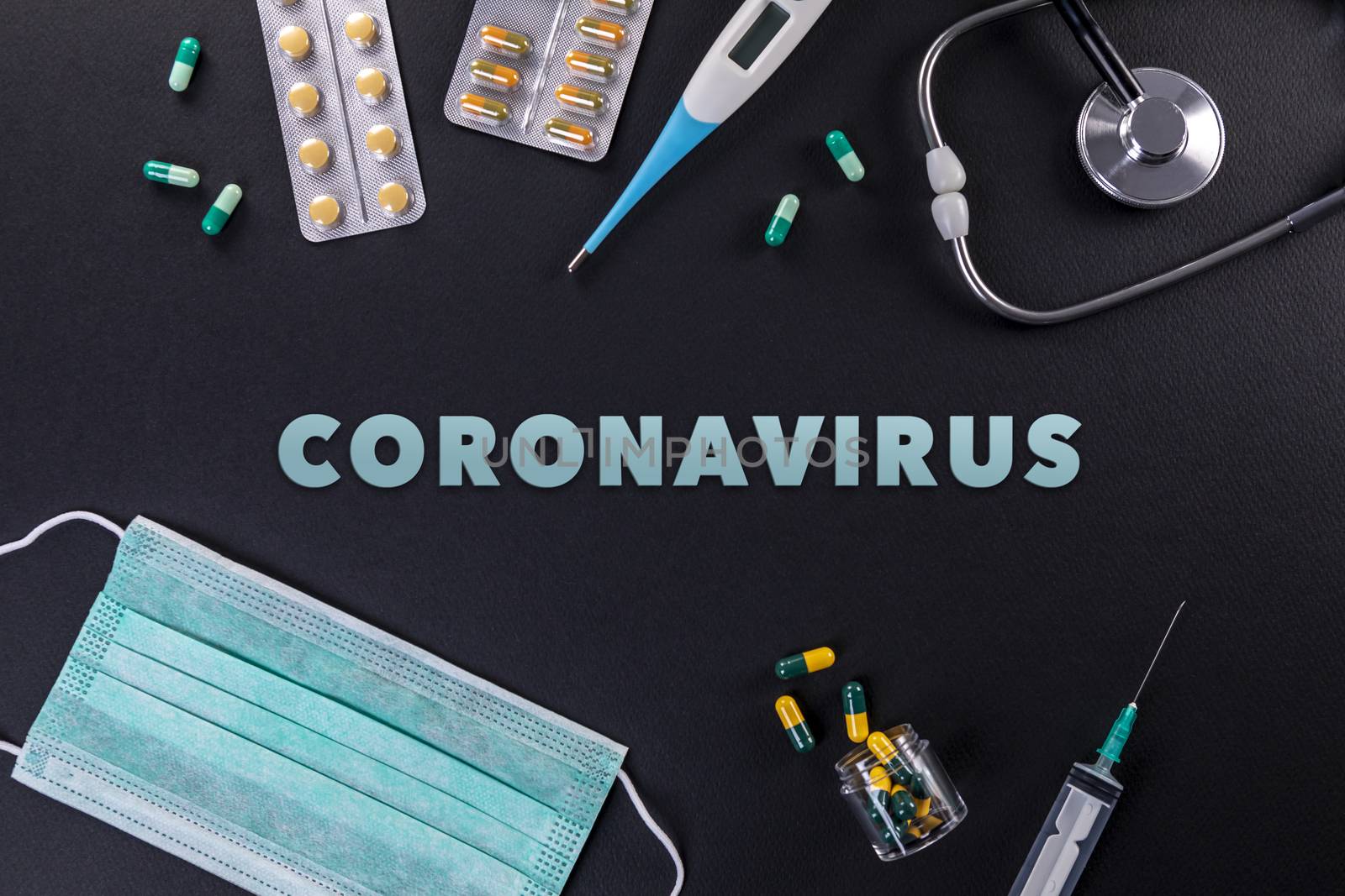 Protective masks, medicines, thermometer, stethoscope and syringe with coronavirus text on a black background. Novel coronavirus 2019-nCoV, MERS-Cov middle East respiratory syndrome coronavirus.