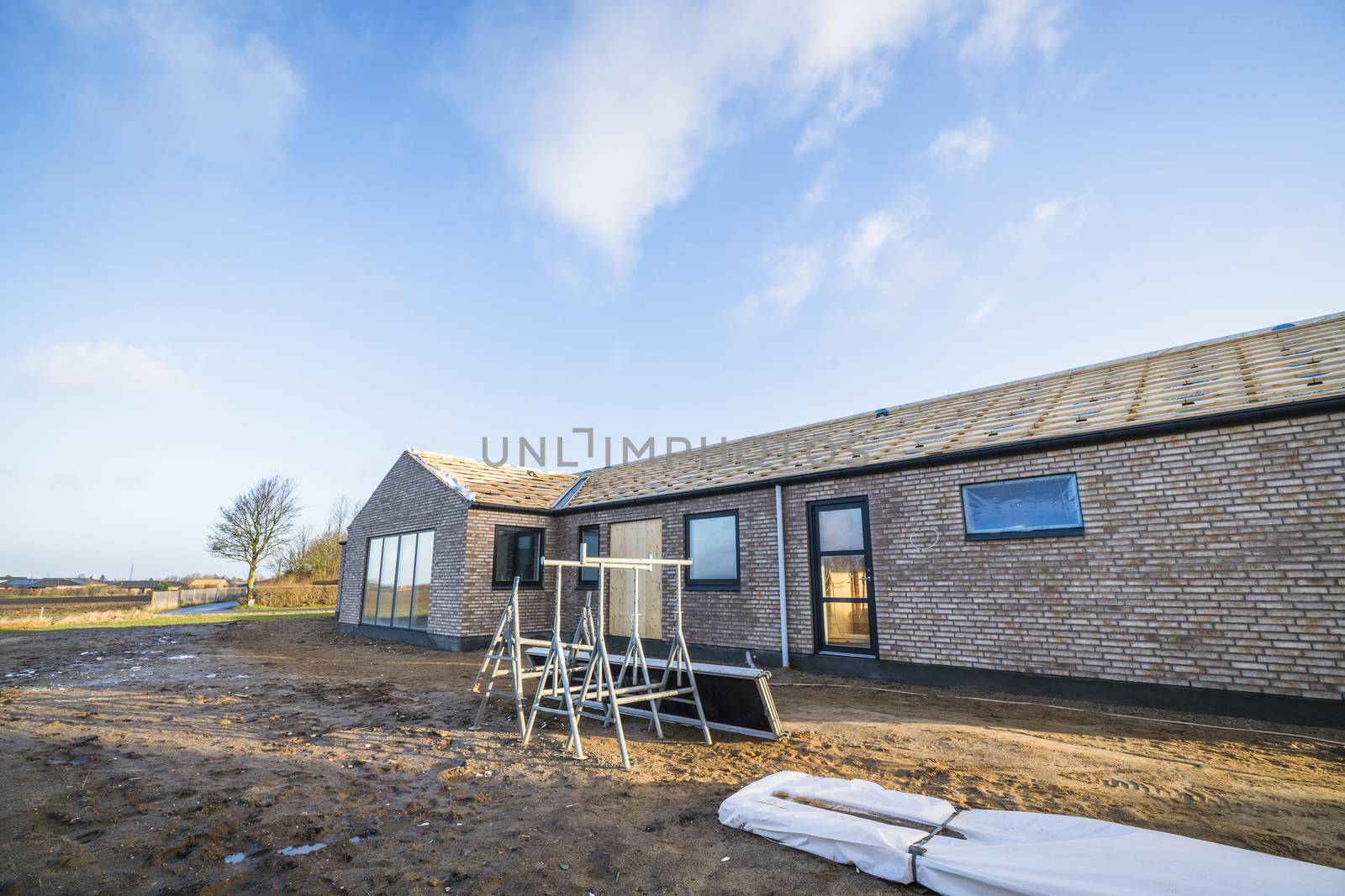 New house made of bricks at a construction site by Sportactive