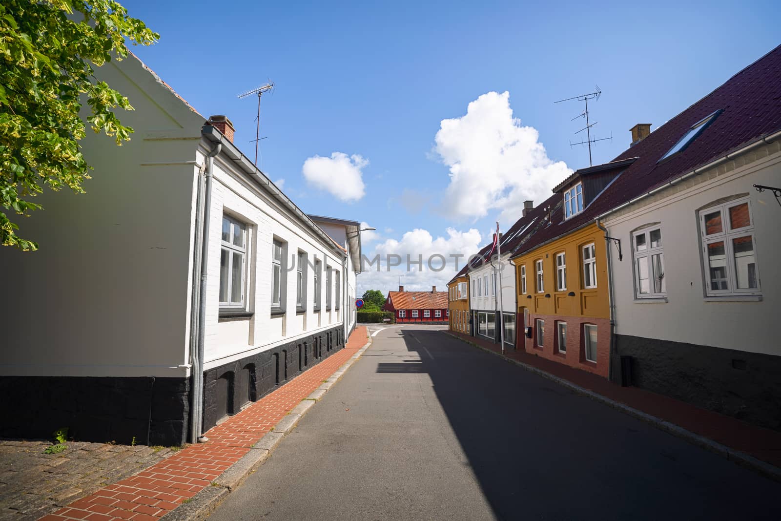 Empty street in a small danish village with colorful buildings in the summer