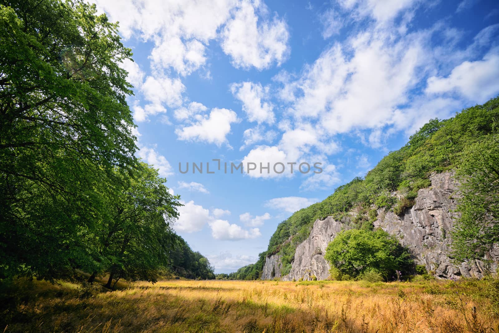 Rural landscape with cliffs and dry fields under a blue sky in the late summer