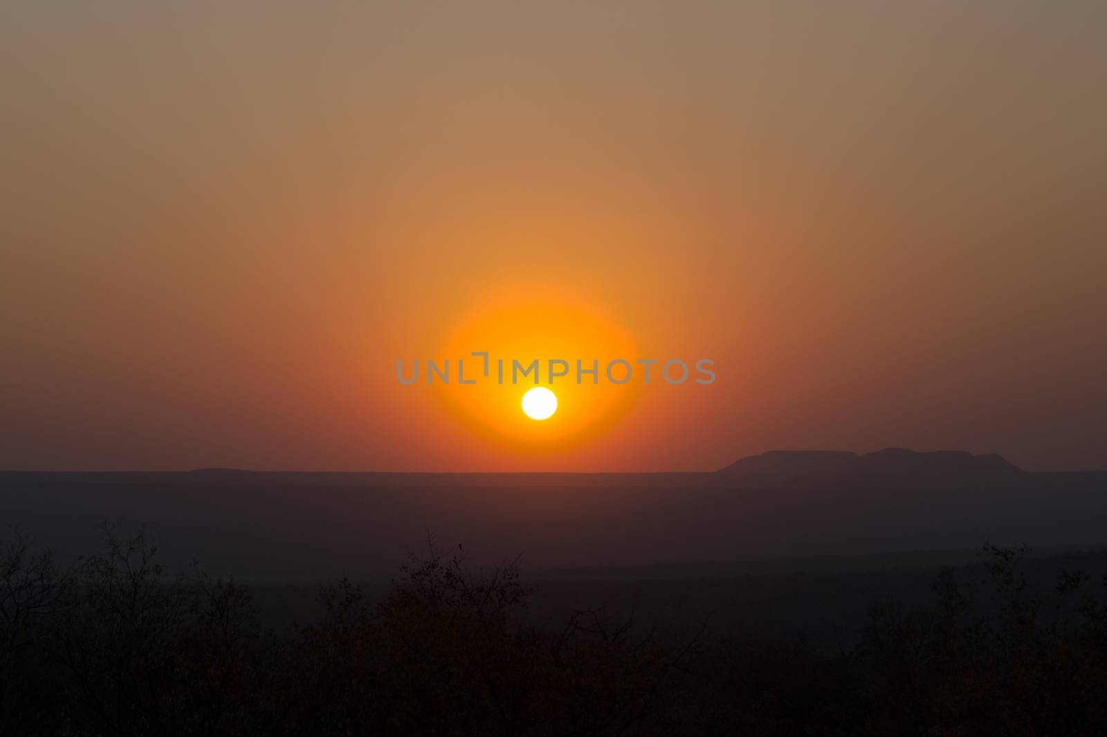 Red sunset over a large area with hills and cliffs in the indian summer