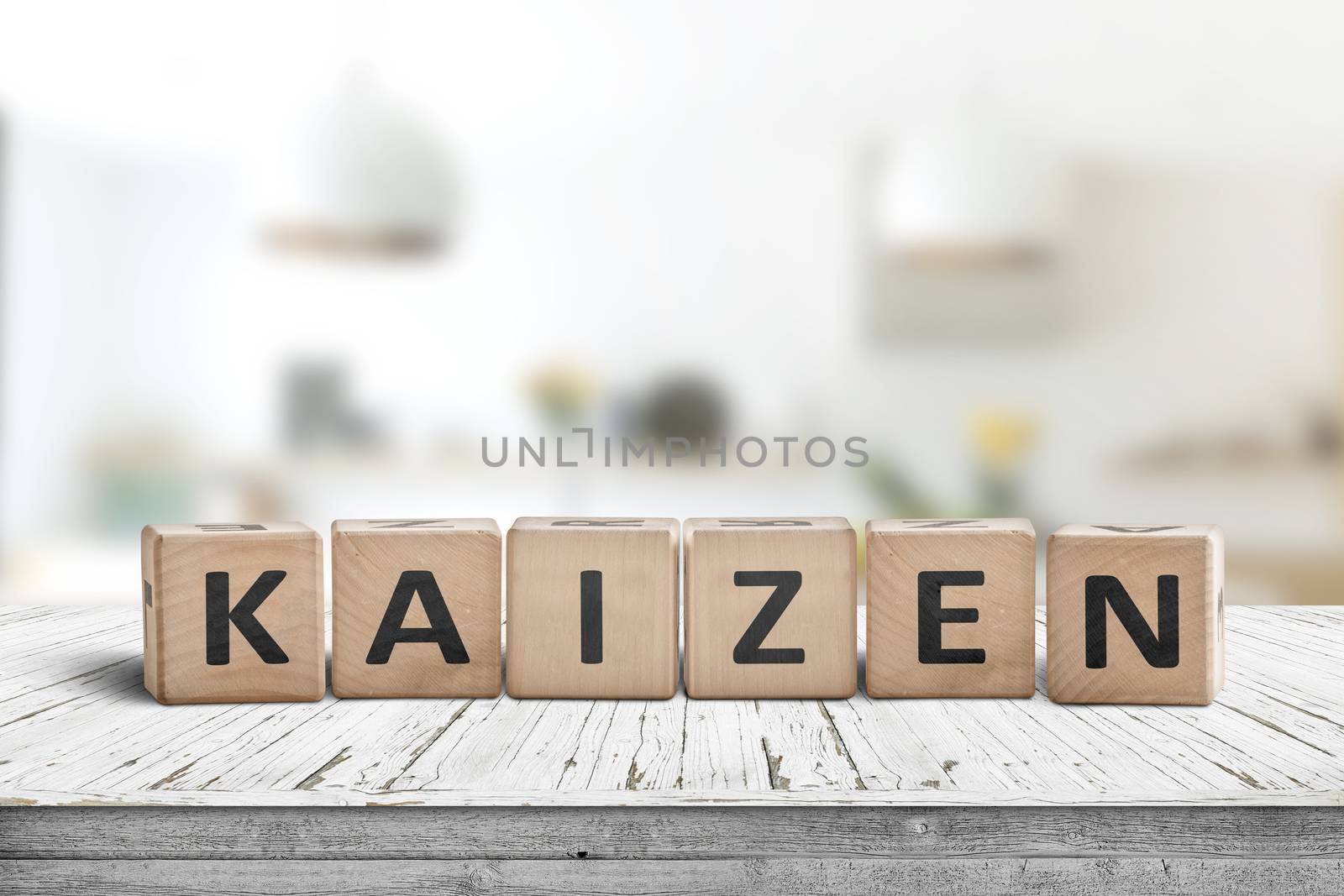 Kaizen improvement sign made of blocks on a wooden desk in a bright room