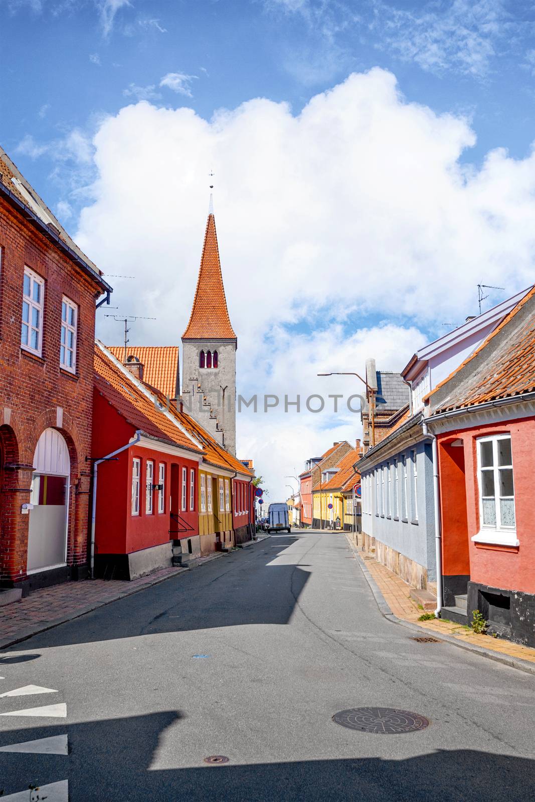 Village with a church in Denmark under a blue sky in the summer