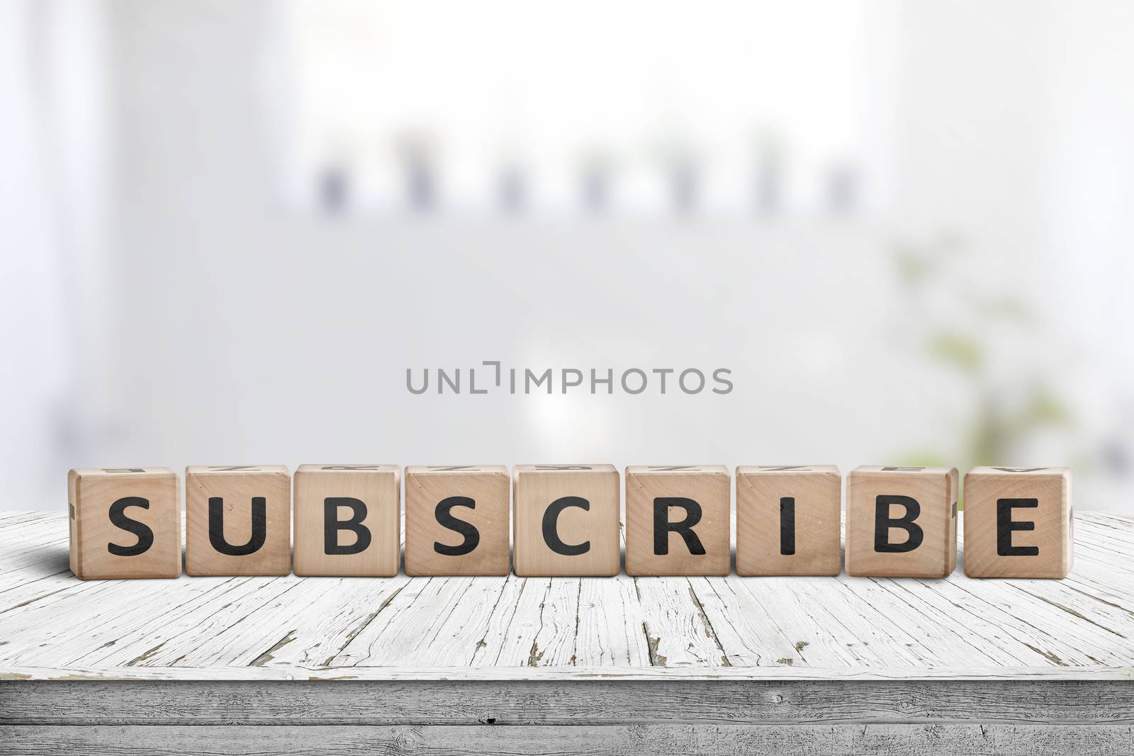 Subscribe word on a wooden sign on a table in a bright room