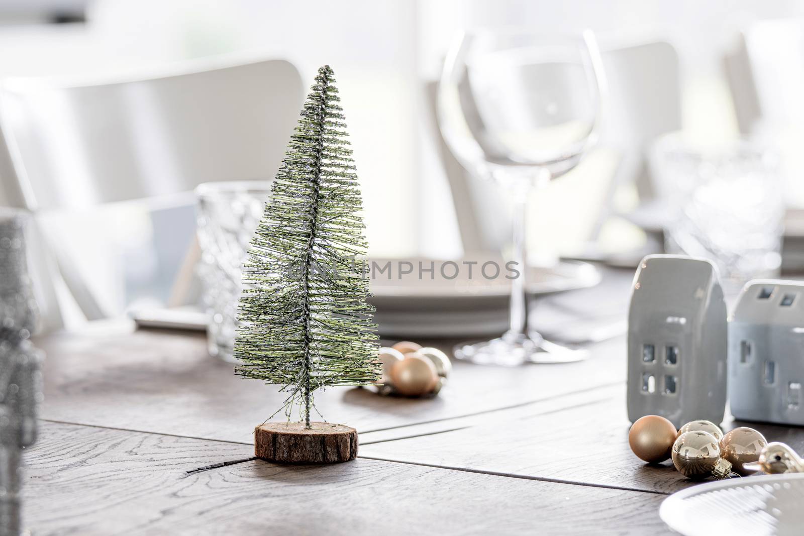 Christmas dinner decoration with a Xmas tree and elegant baubles on a table