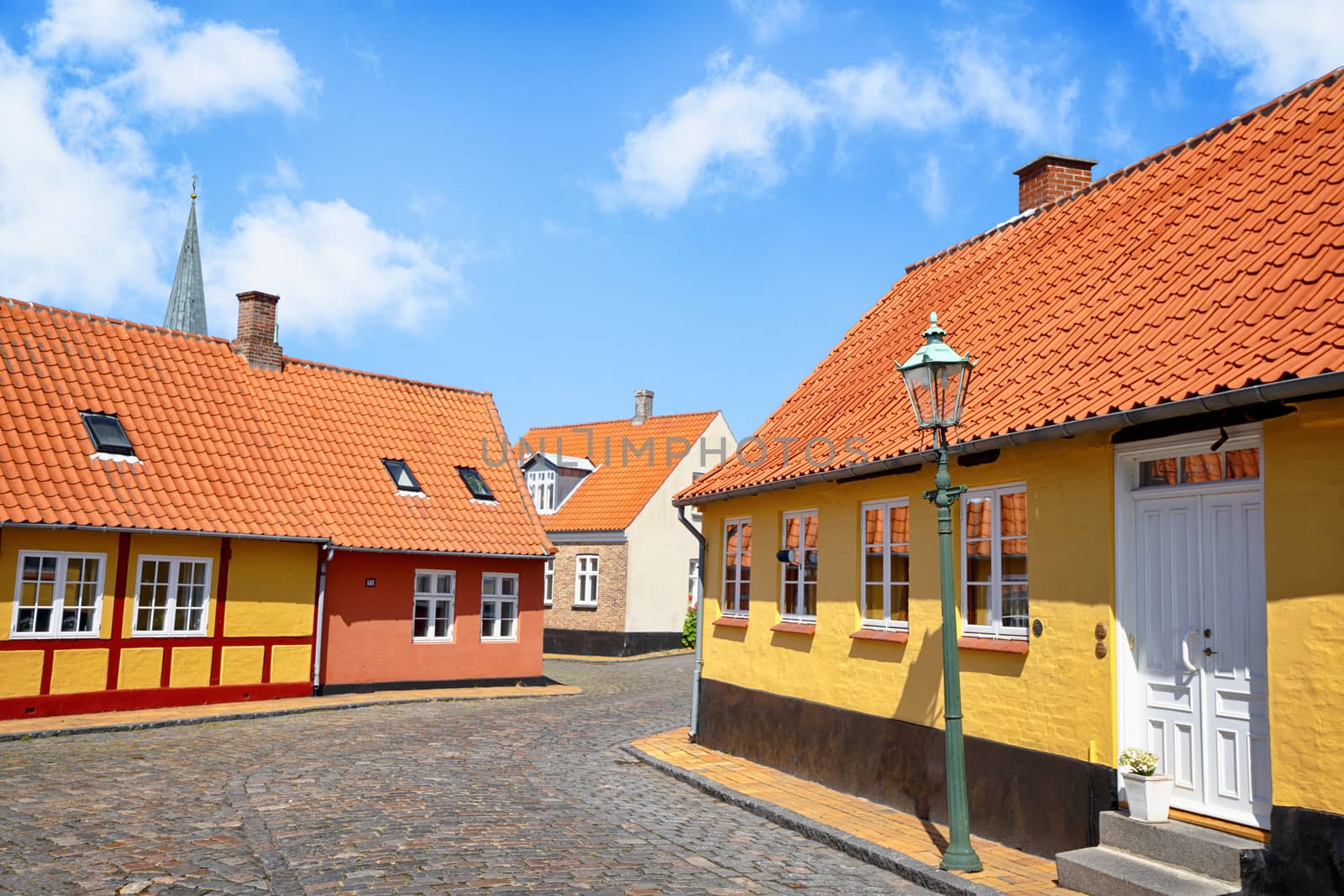 Street with yellow buildings and cooblestone by Sportactive