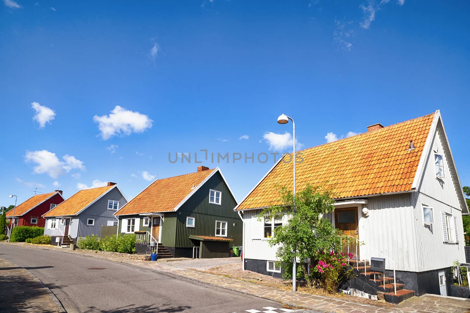 Street with residences on a row under ablue sky in the summertime