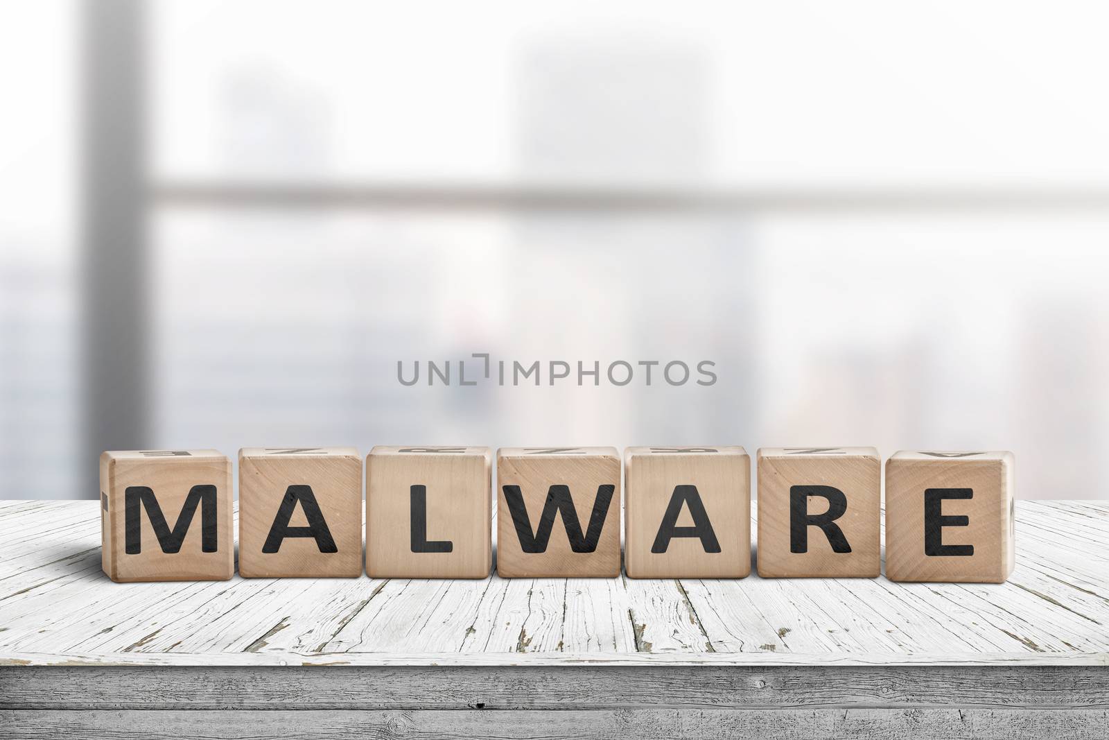 Malware message sign made of wood on a desk in a bright office environment