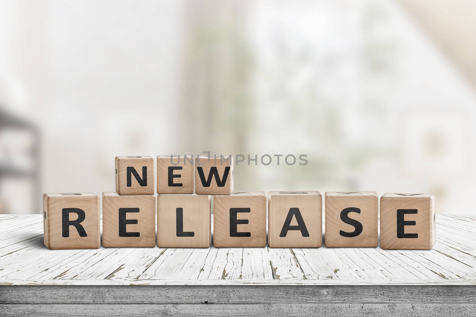 New release sign on a wooden table in a bright room with a green tone