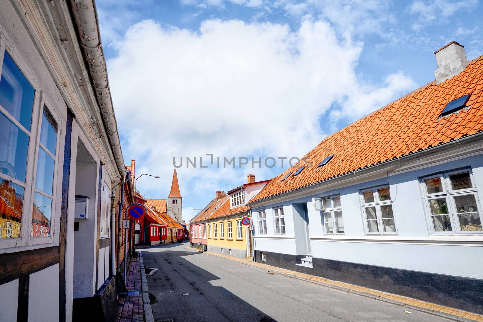 Danish village in the summer with red rooftops under a blue sky