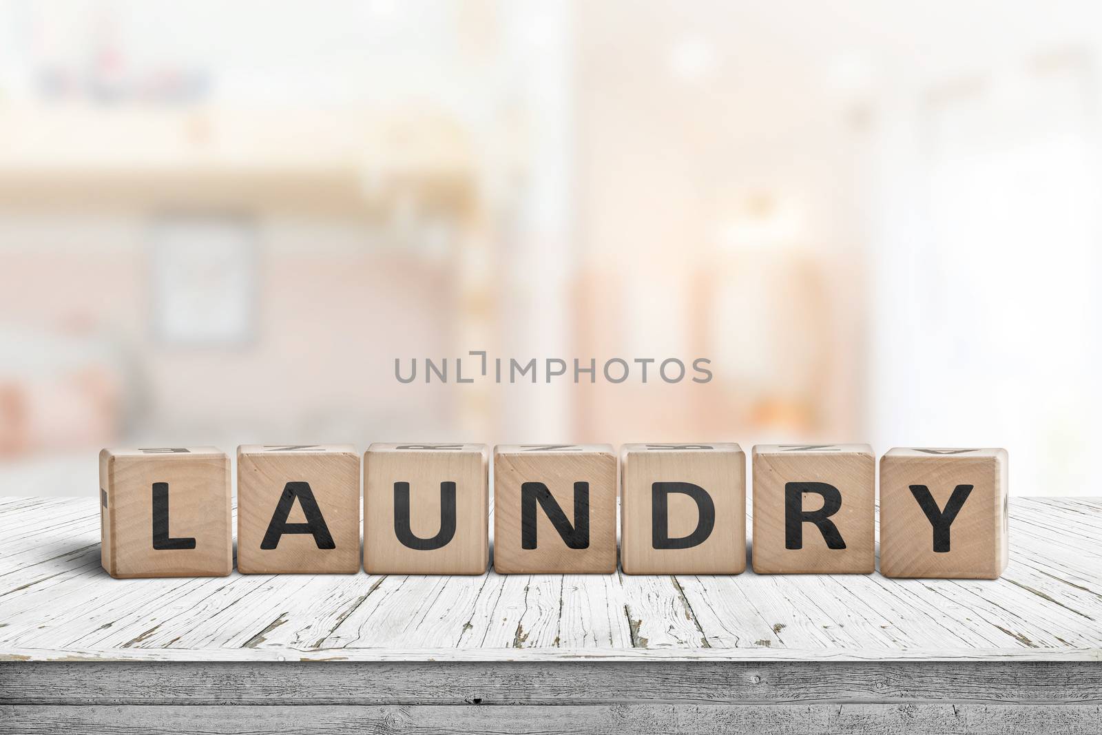 Laundry sign on a white table in a bright living room with sunlight coming in by the window