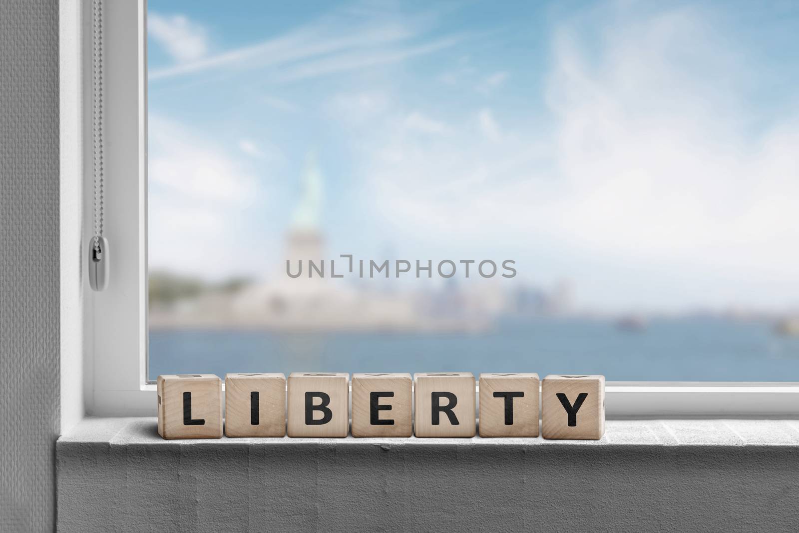 Liberty sign in a window sill with a view to the statue of liberty