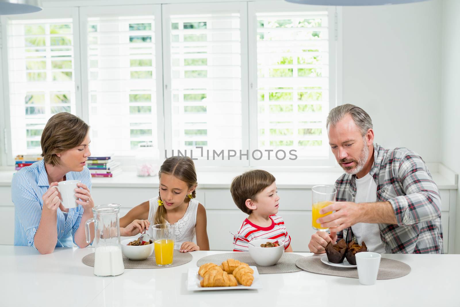 Family having breakfast in the kitchen at home