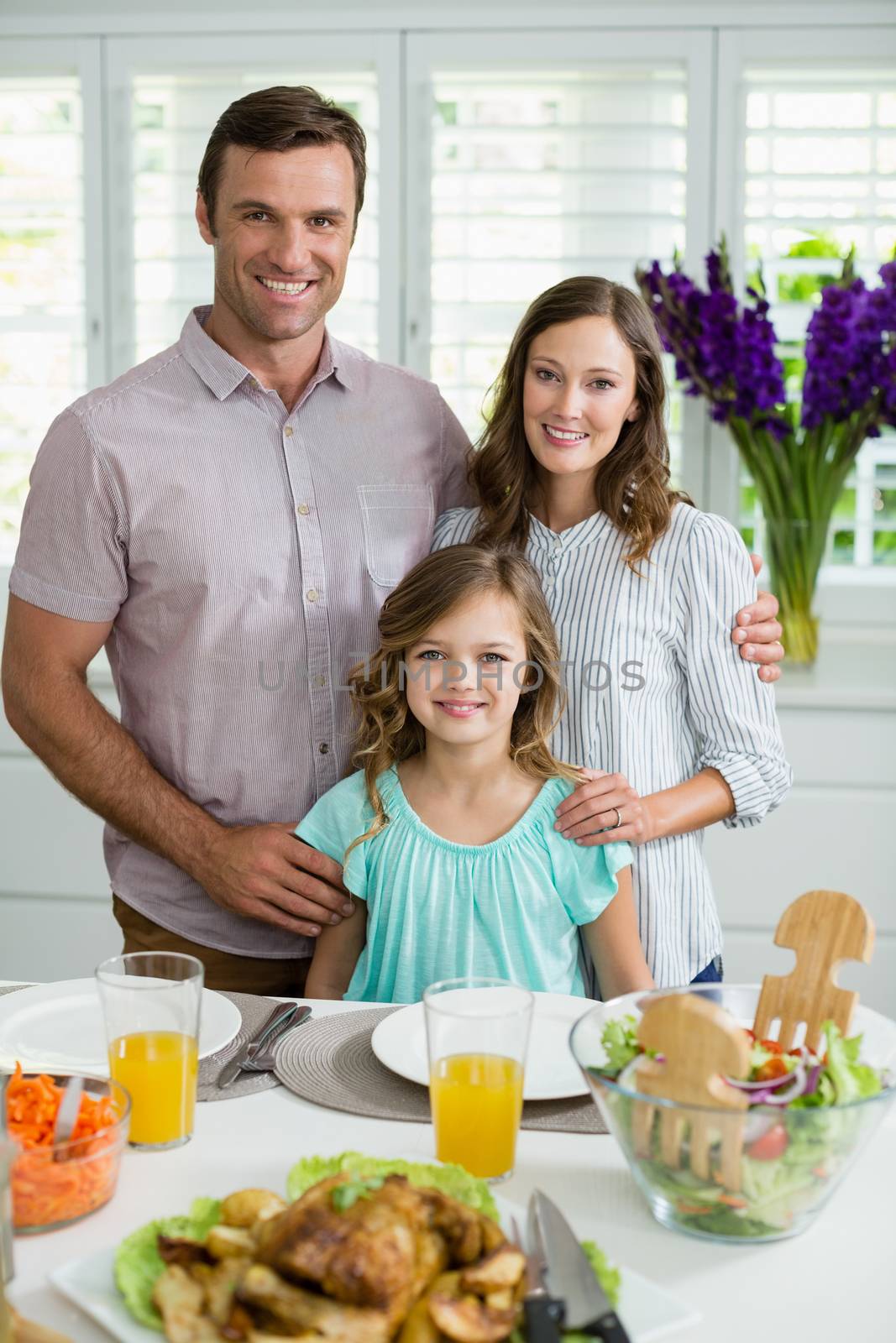 Portrait of smiling family having lunch together on dining table by Wavebreakmedia