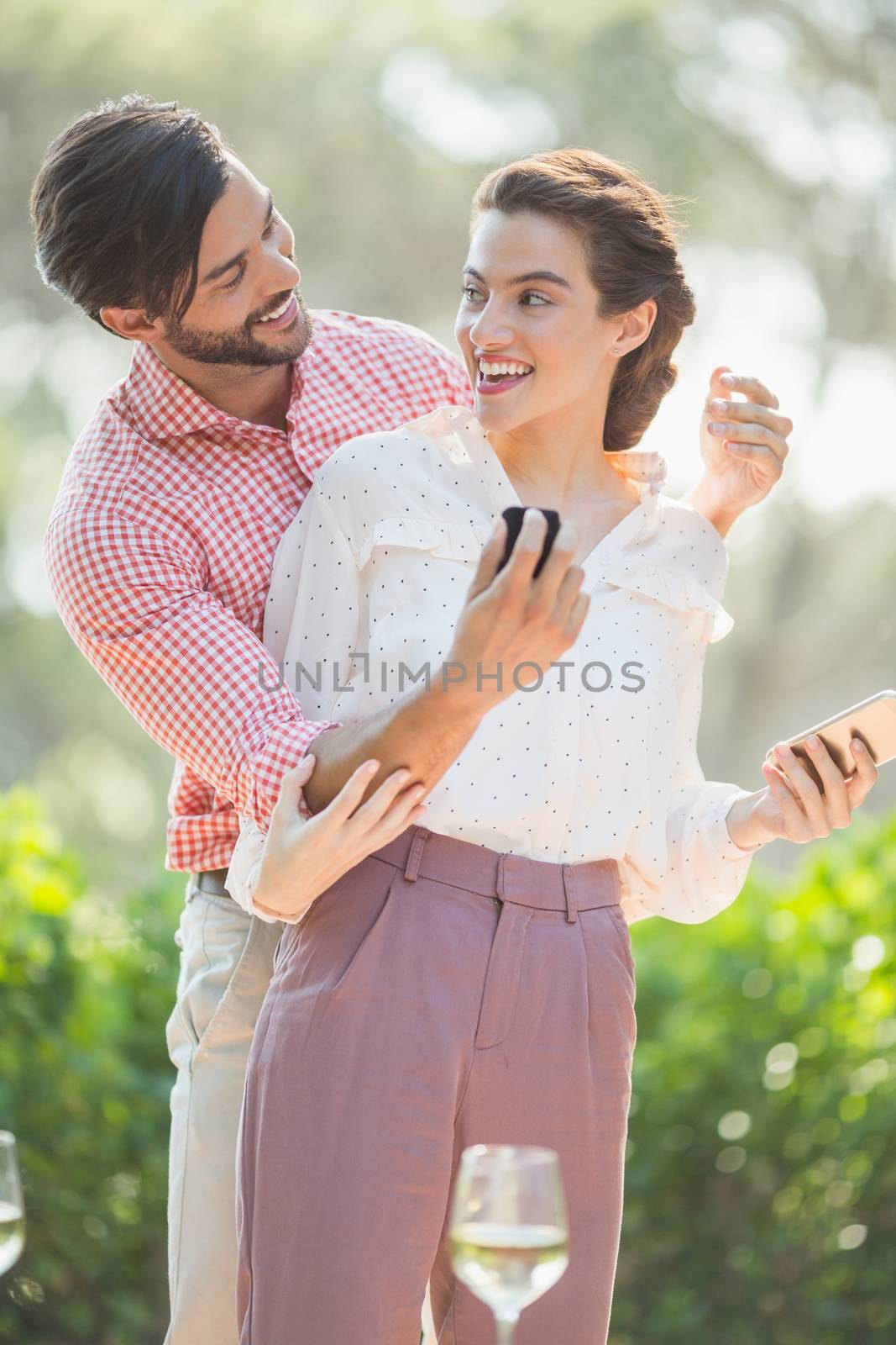 Man proposing a woman with a ring in the restaurant