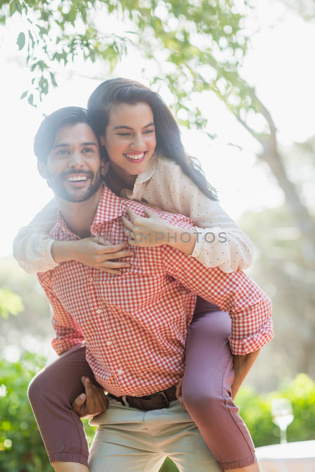 Man giving piggyback ride to woman in the restaurant