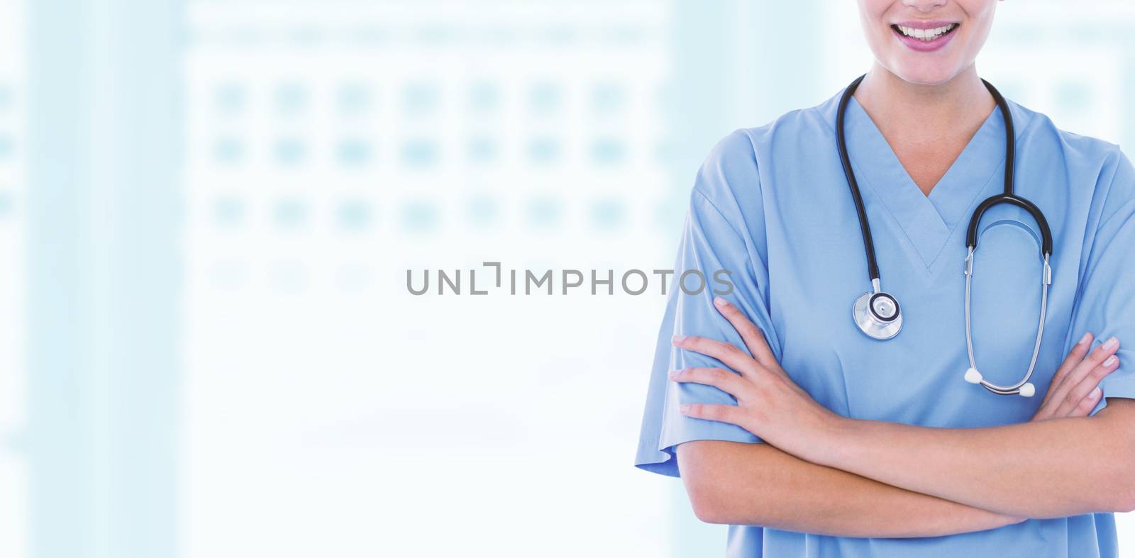 Happy doctor looking at camera with arms crossed  against dental equipment