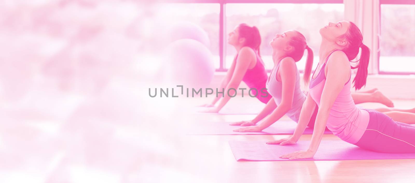 Glowing background against friends exercising on mats