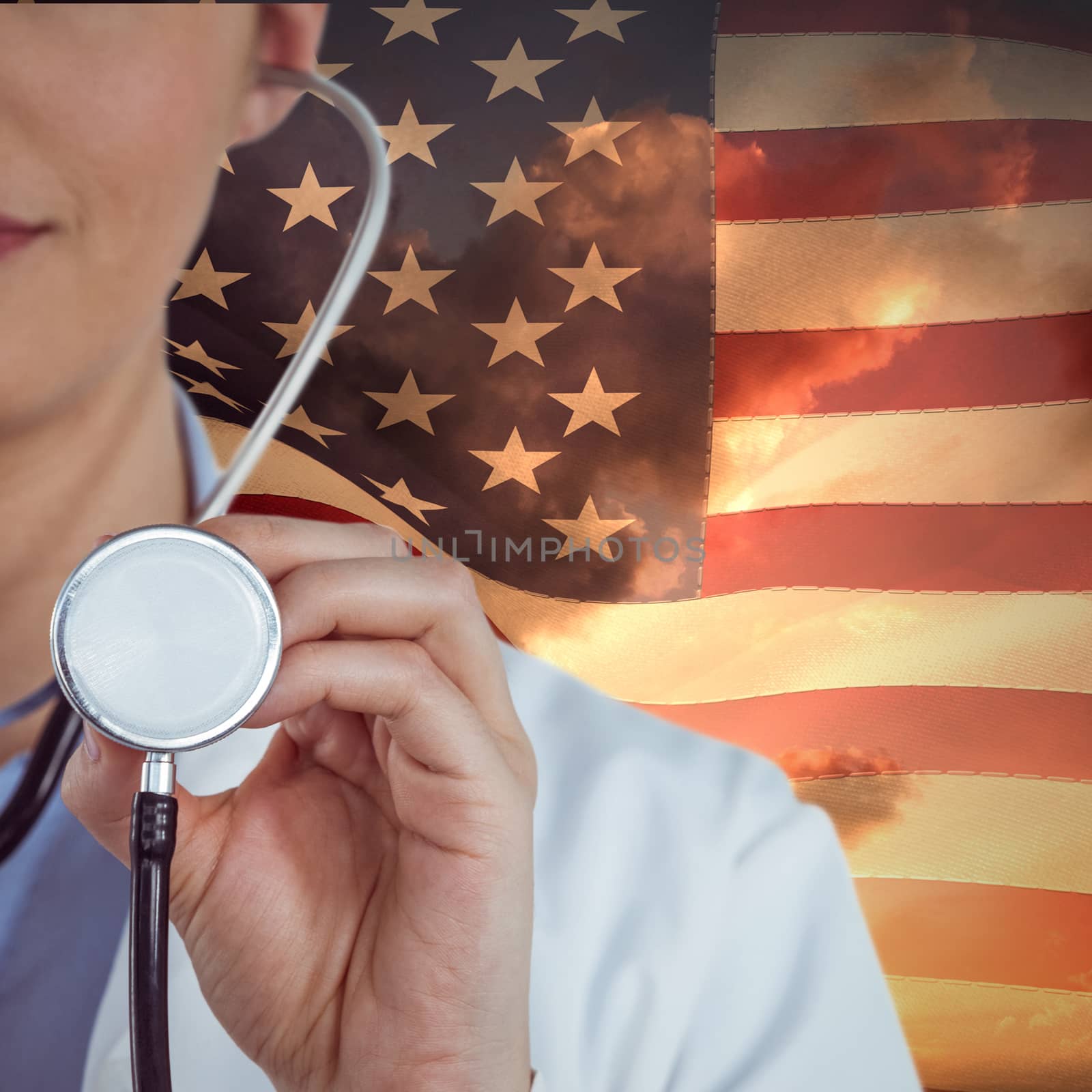 Close-up of female doctor holding stethoscope against american flag against sky during sunset