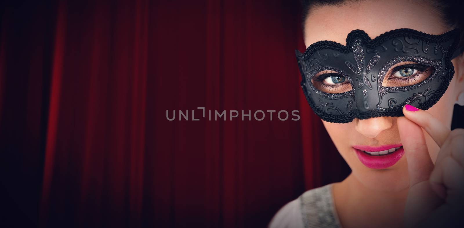 Red curtain against woman wearing black mask