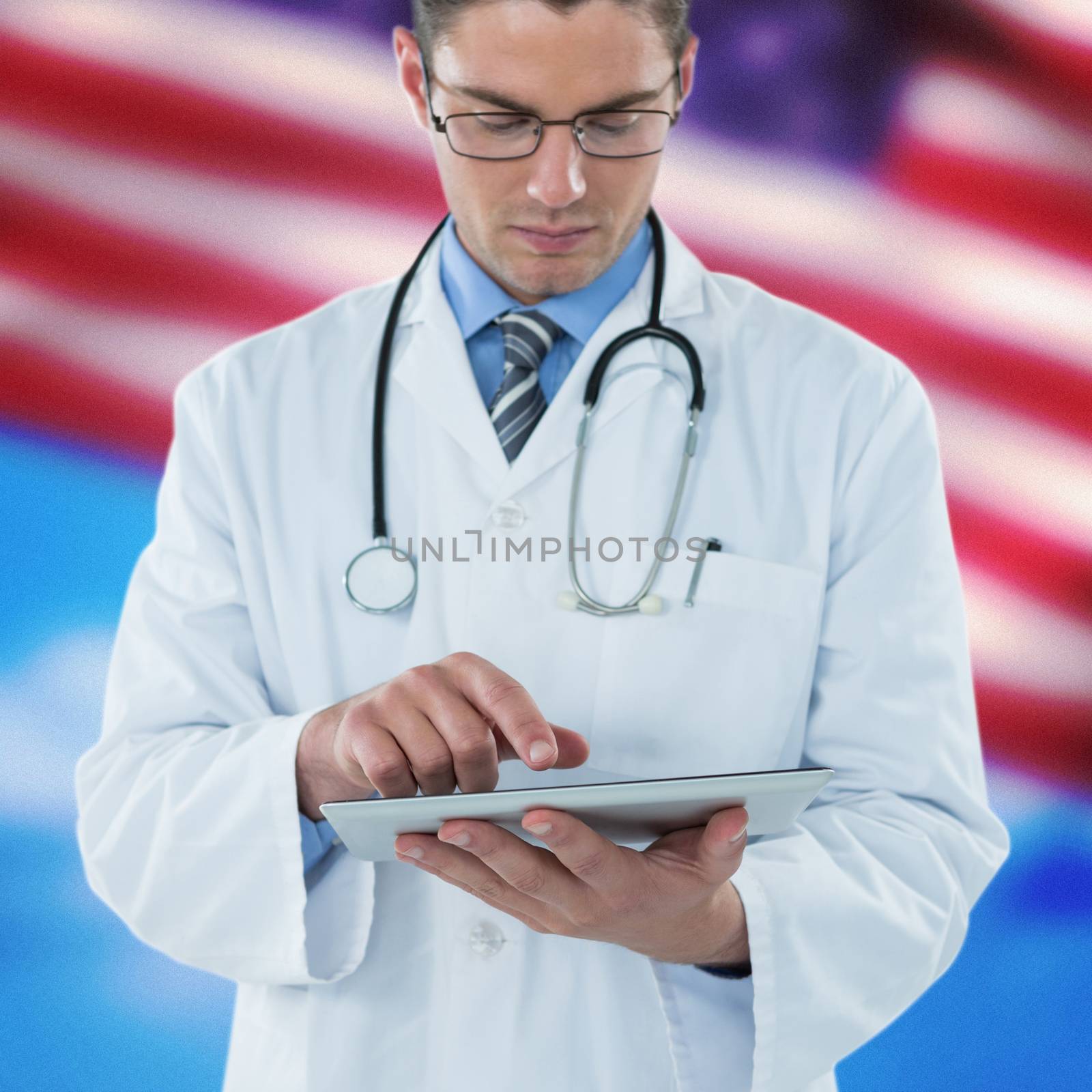 Young doctor using digital tablet against composite image of close-up of american flag