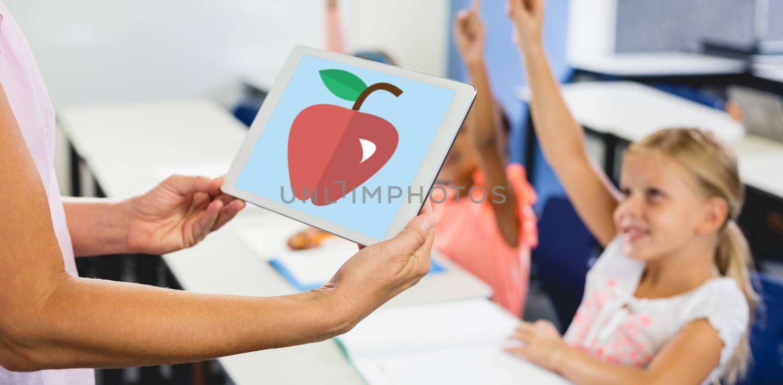 Print against female teacher holding digital tablet in classroom