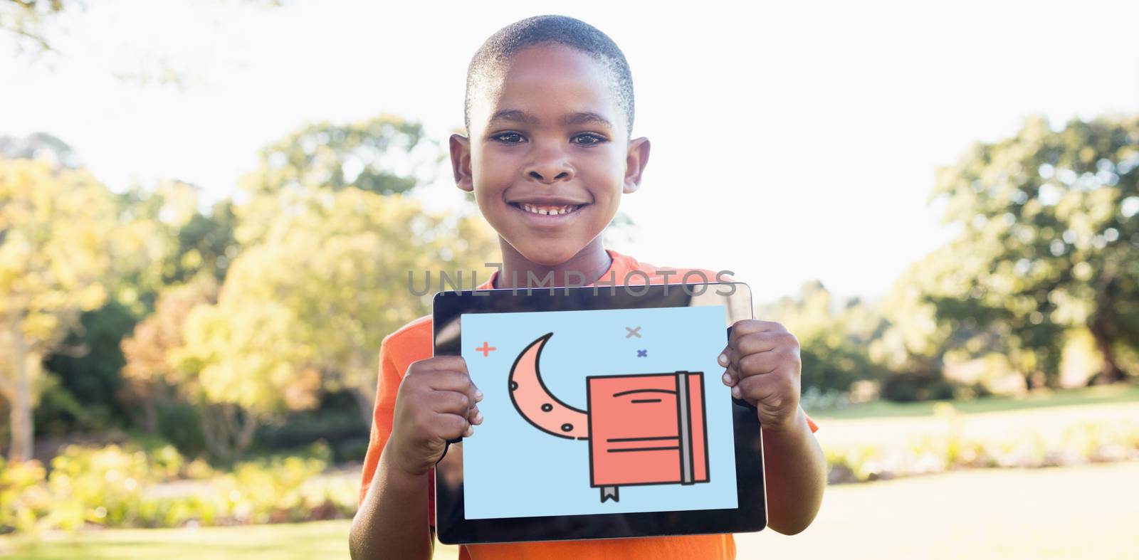 Print against portrait of boy smiling while holding digital tablet